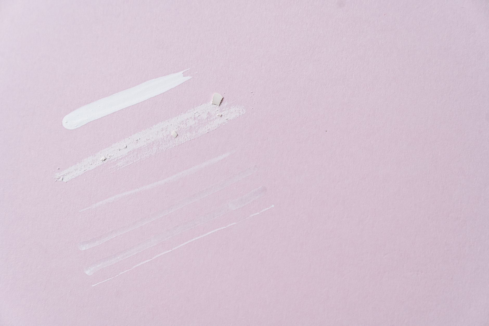 a collection of gentle baby skin care products—zinc oxide ointment tube, aloe gel jar, and a soft cloth—arranged on a pastel background, natural lighting