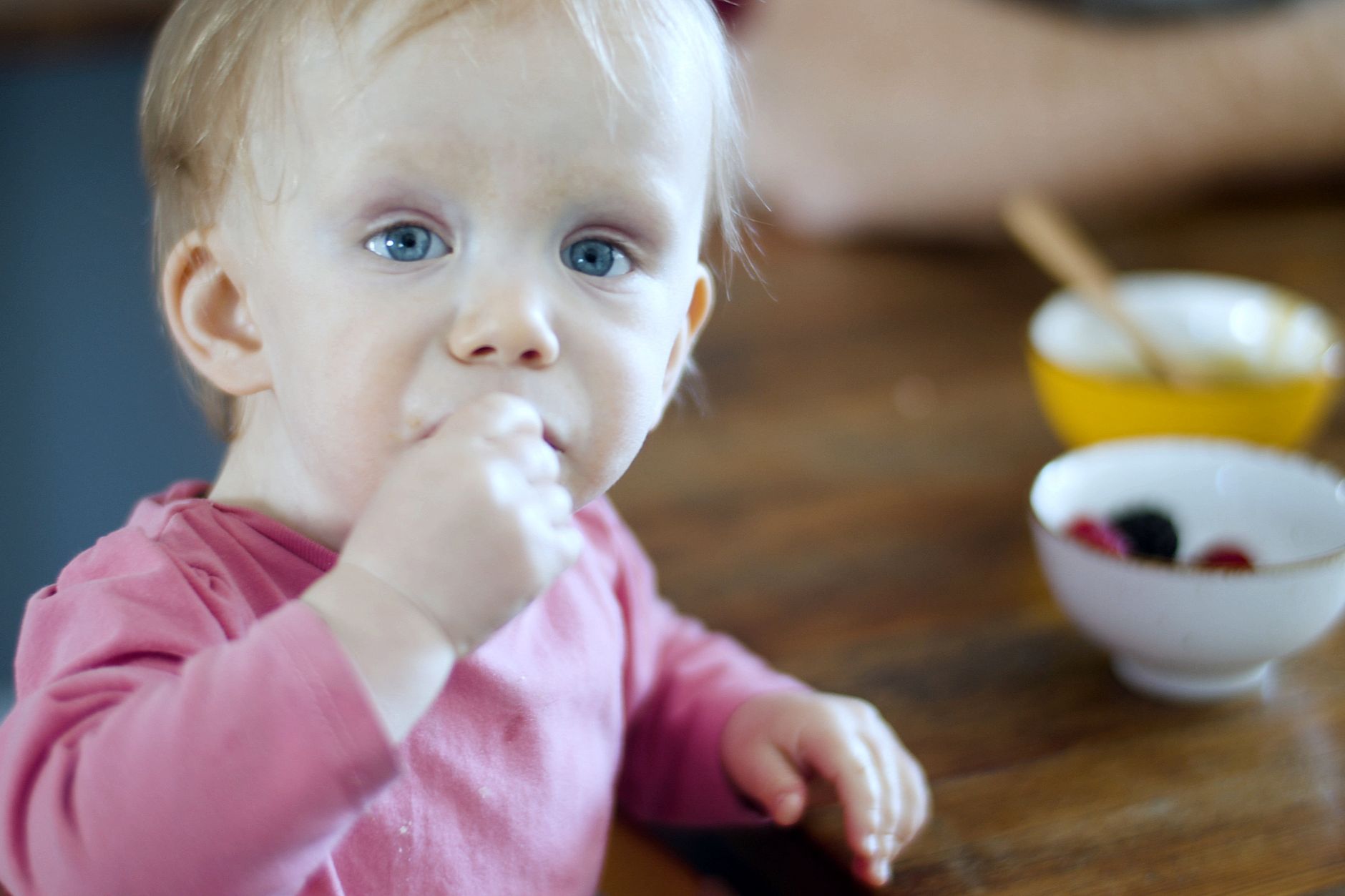 Baby sitting at a Montessori weaning table with a small bowl of food