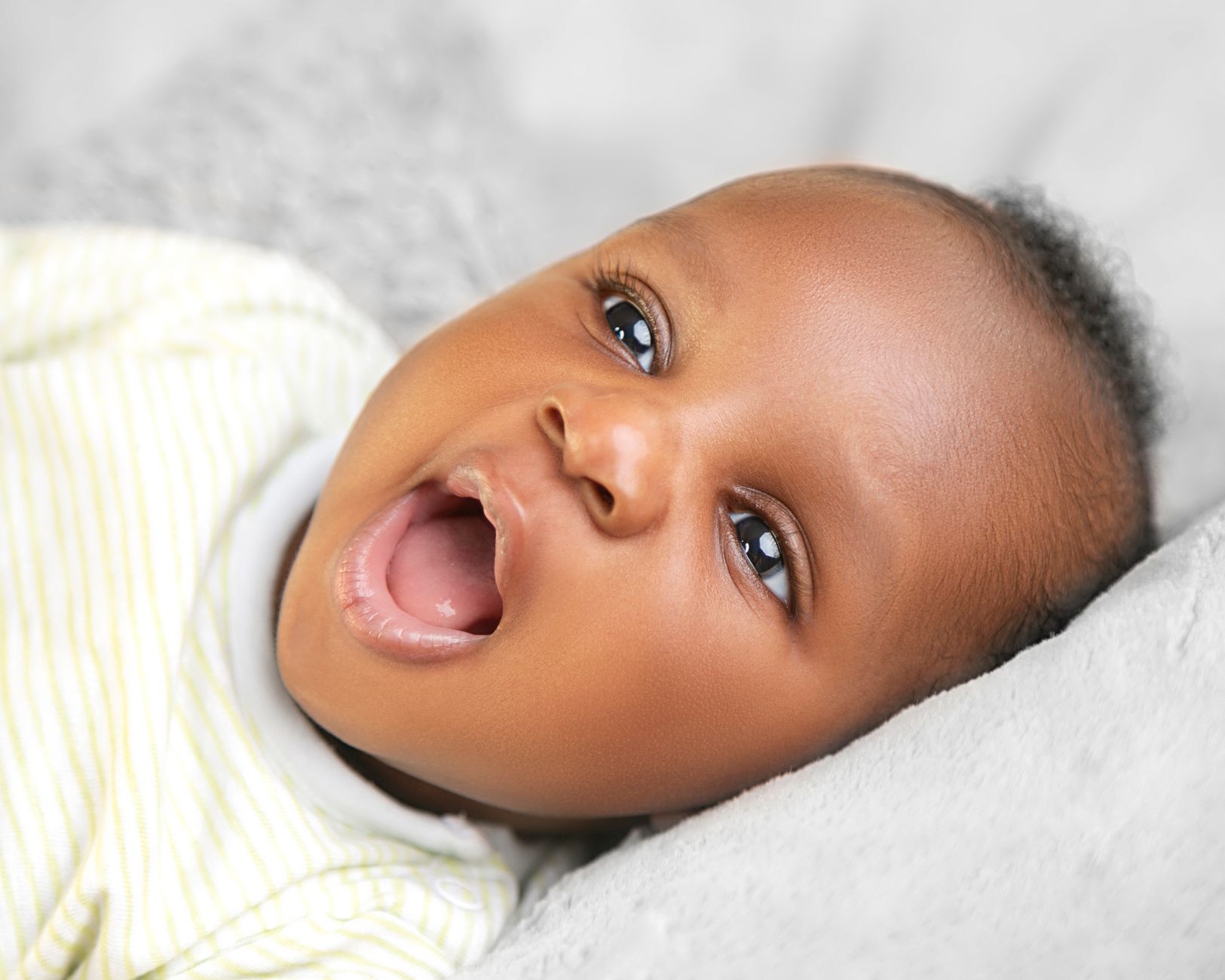 Parent using a dropper to apply antifungal medication to a baby's mouth