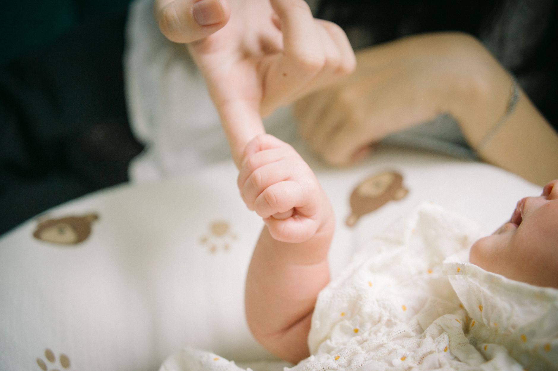 A cozy indoor scene with a parent baby‑wearing, illustrating close skin contact