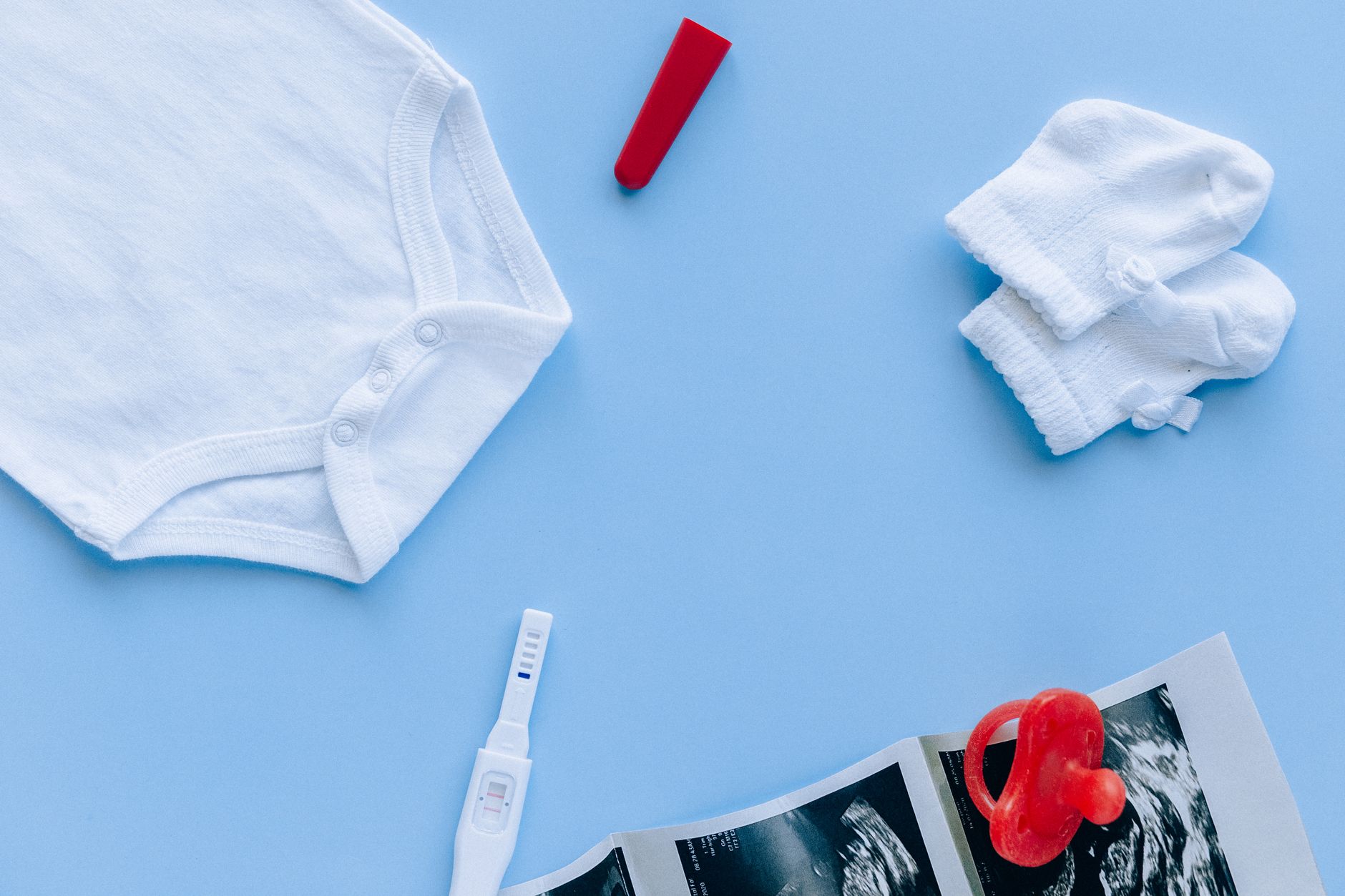 Flat lay of baby items with registry app on screen