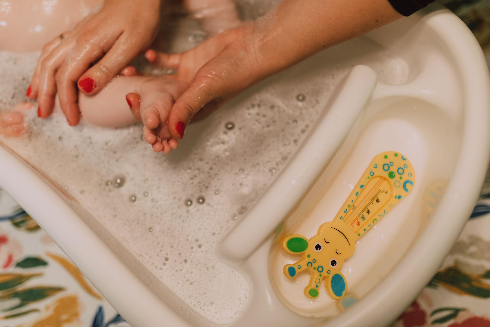 Baby hand testing water temperature