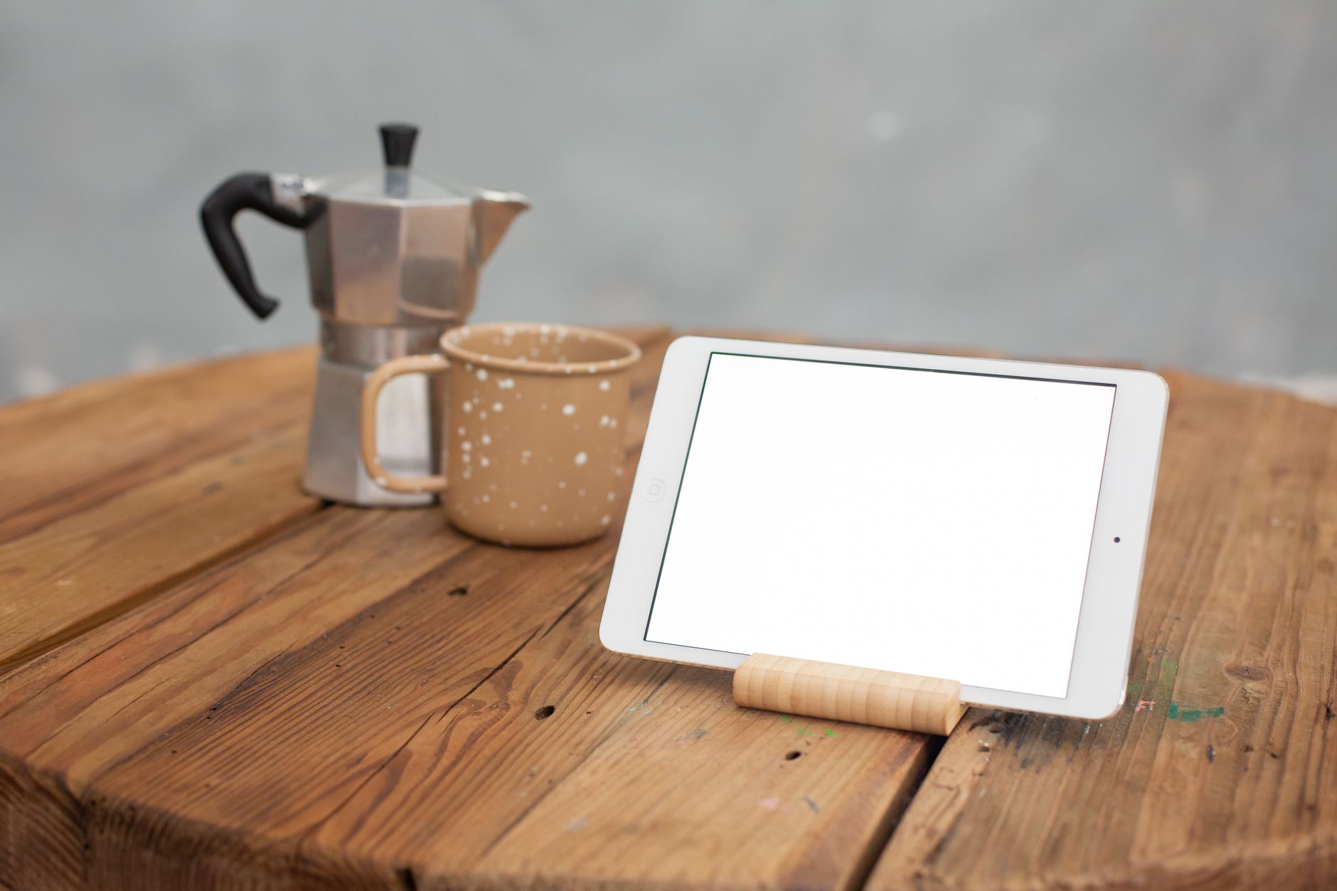 A pregnant woman holding a tablet showing a nutrition tracker, soft indoor lighting, wooden table with a cup of tea, warm cozy atmosphere