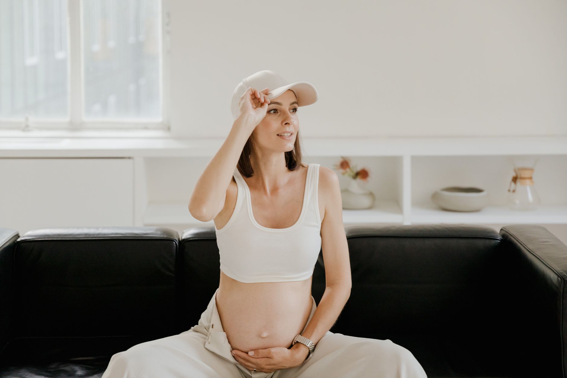 Woman feeling baby movement on couch