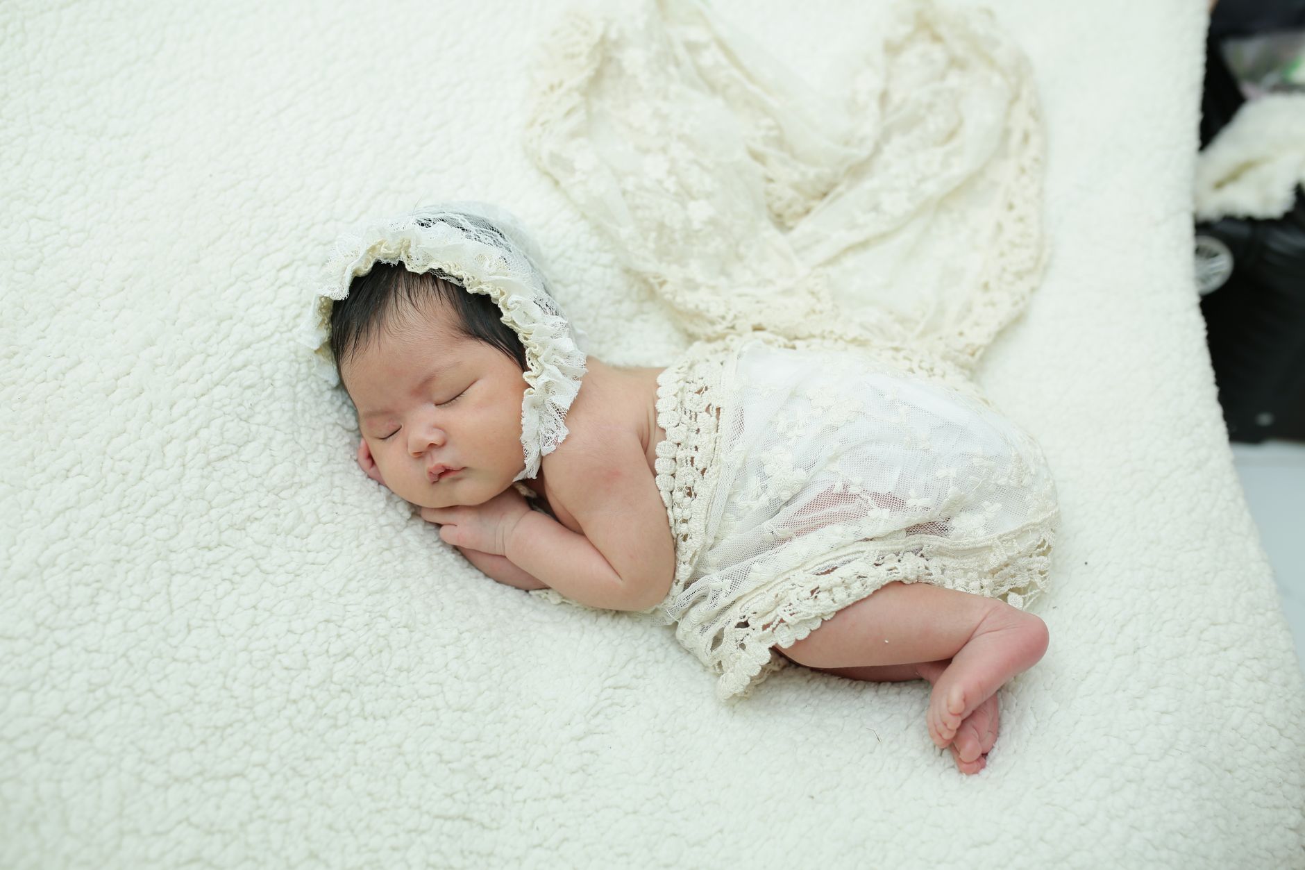 Newborn on safe sleep wedge