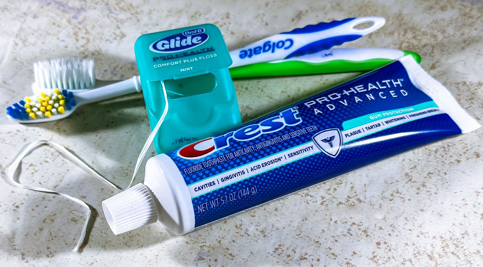 Toddler brushing teeth with fluoride toothpaste and drops