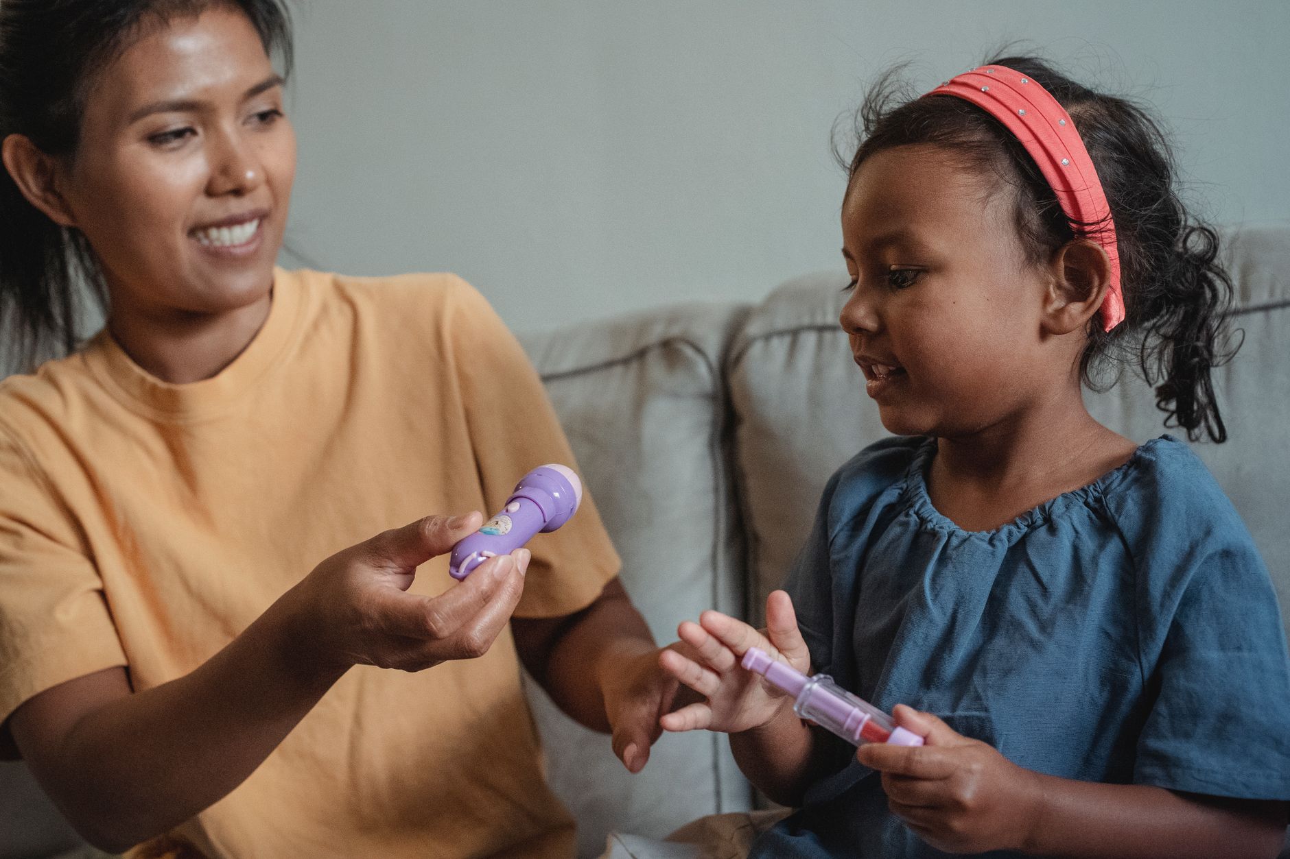 Parent using bulb syringe on infant