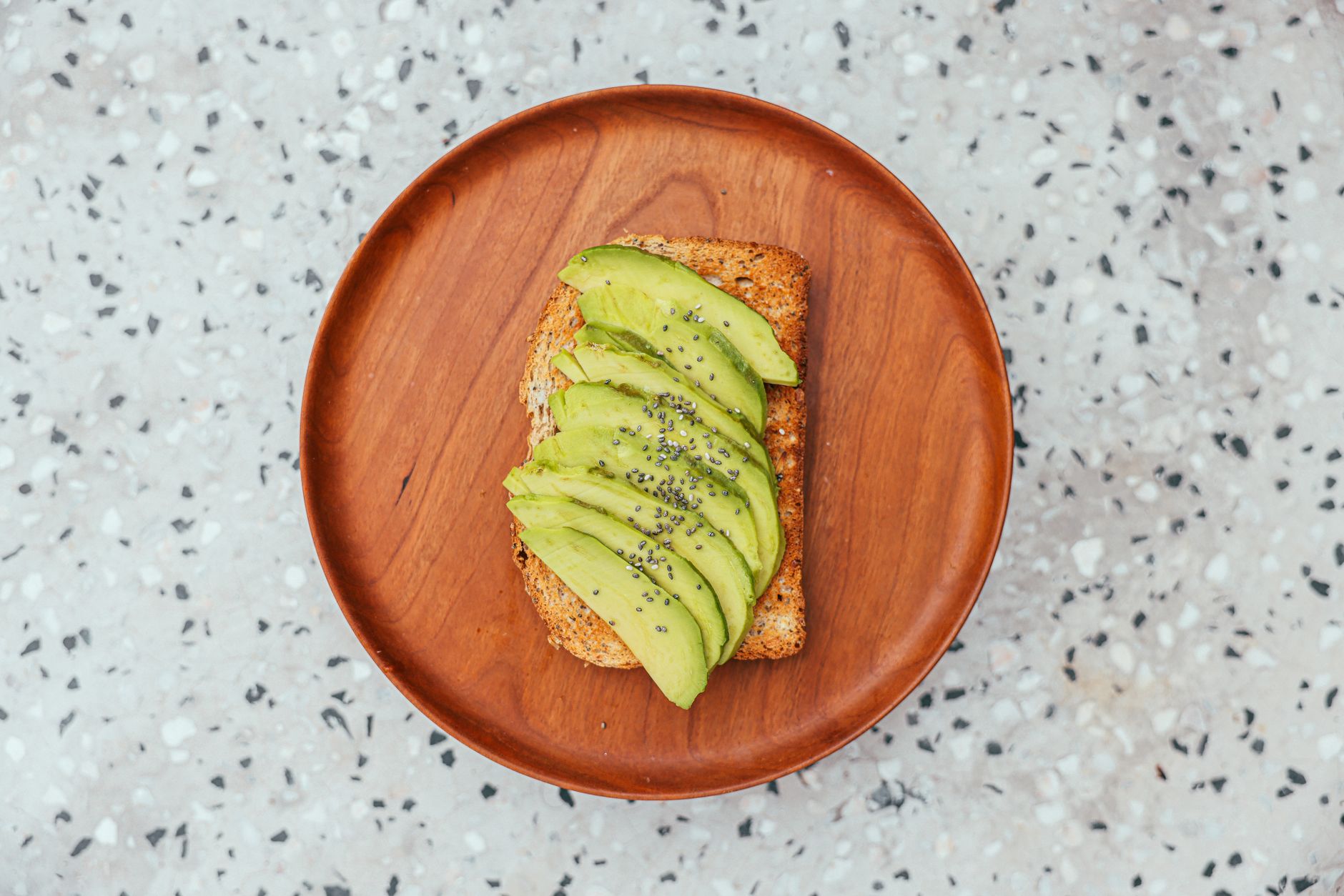 A colorful plate showing a serving of kefir, a handful of almonds, sliced avocado, and a side of whole‑grain toast, bright natural light, inviting breakfast for a pregnant woman