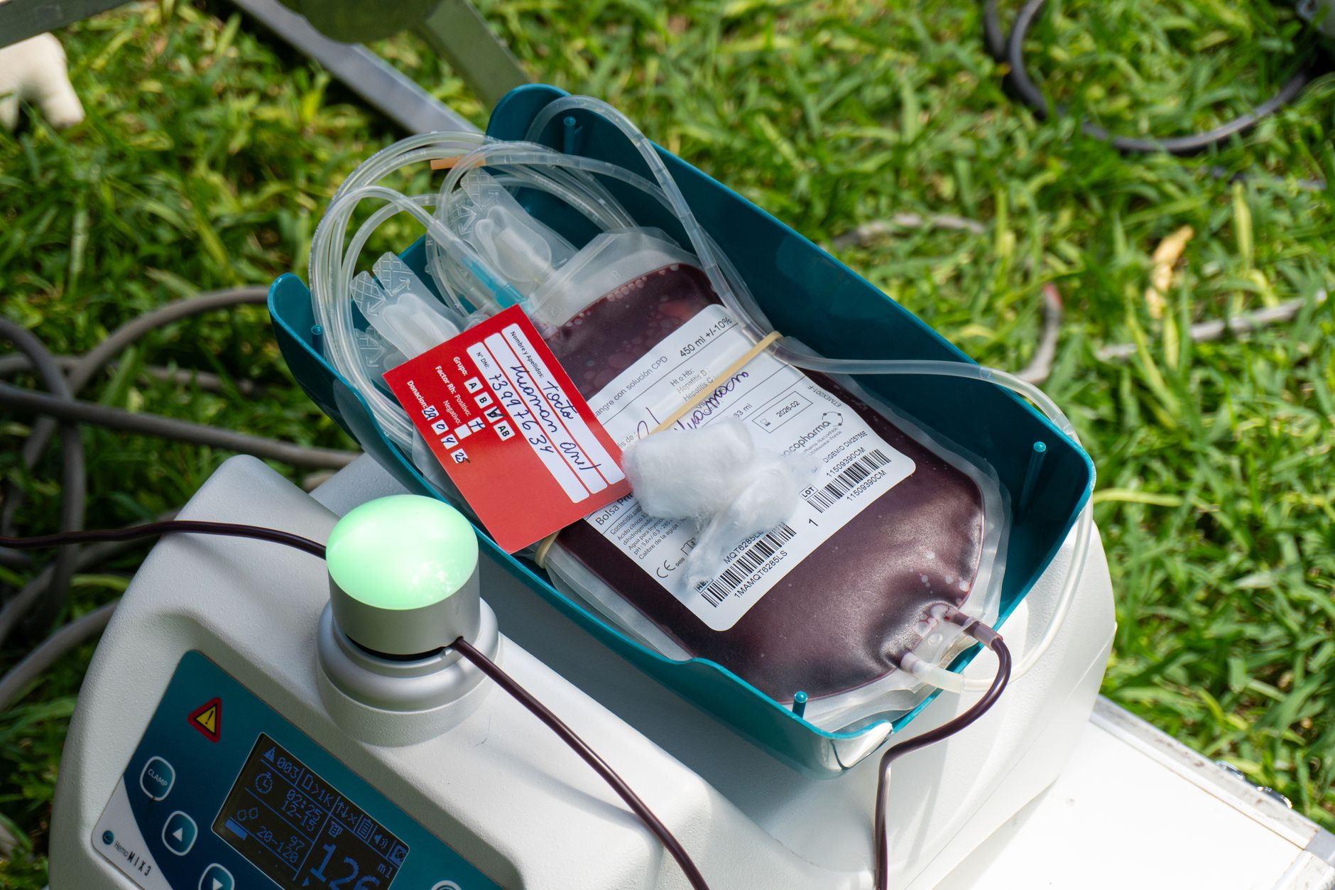 a calm, organized blood drive table with donation forms, a glass of water, and a small potted plant, illustrating a supportive environment for volunteers and donors
