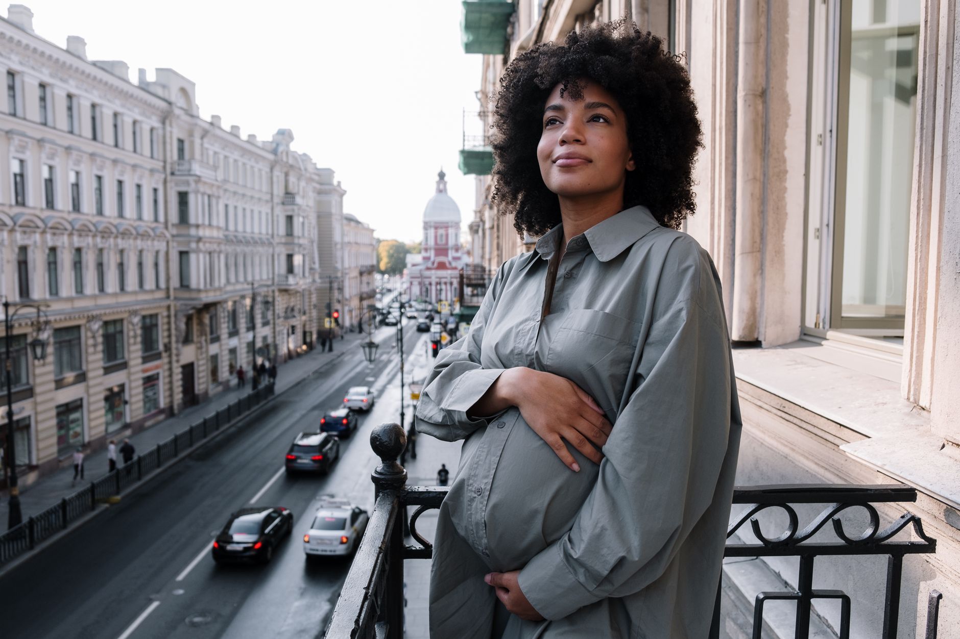 pregnant woman holding a travel itinerary on a cruise ship balcony, emphasizing planning and safety, 95 characters