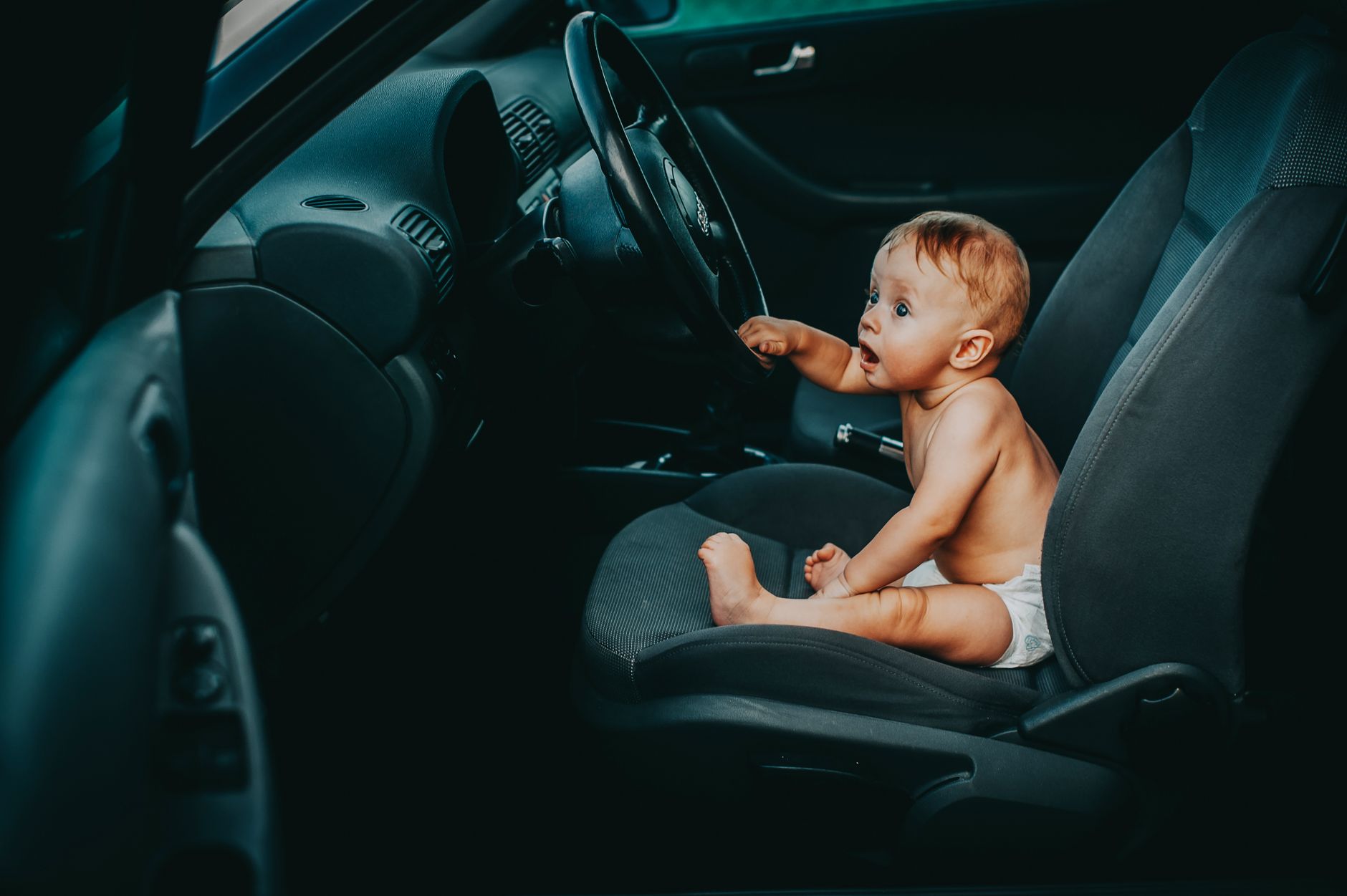 Parent checking car seat harness