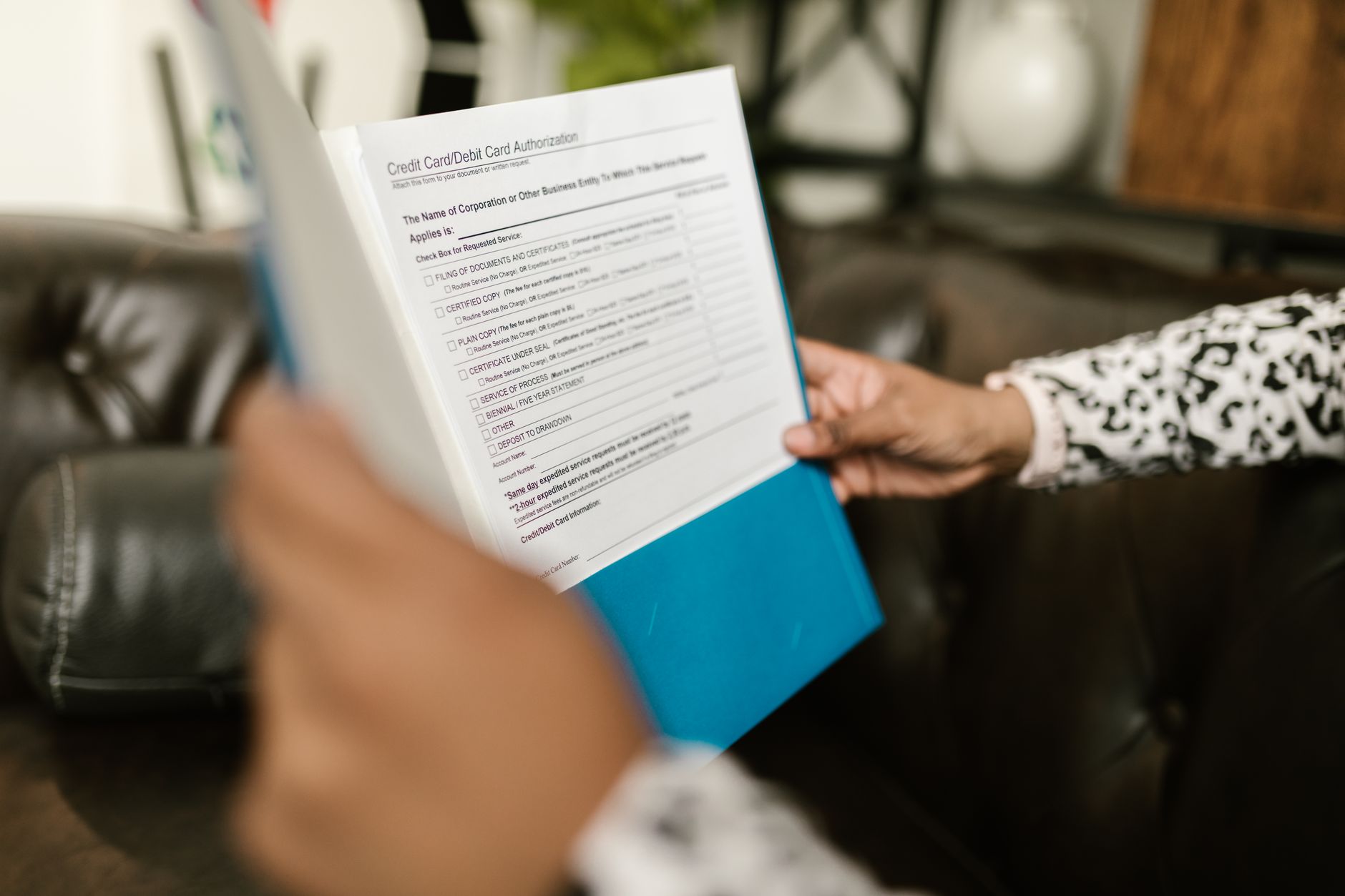 Newborn holding SSN card and birth certificate