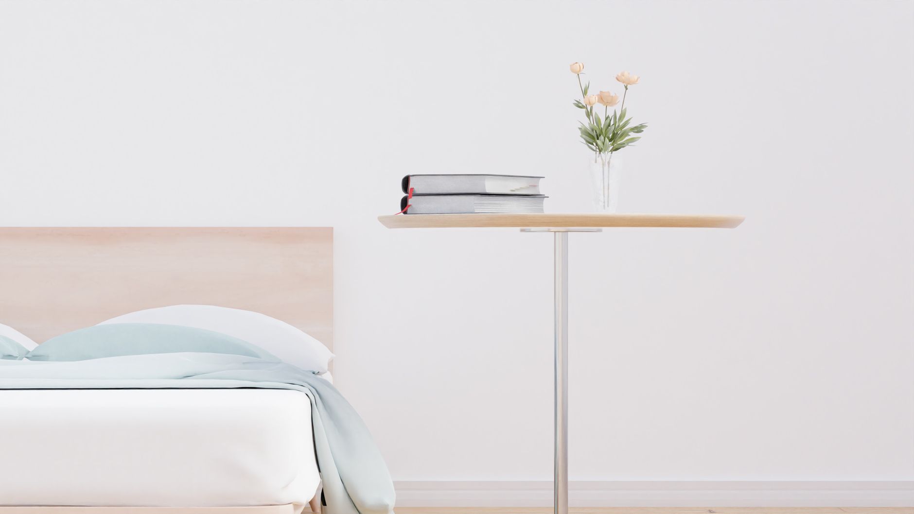 Softly lit birthing suite with a comfortable chair, a bedside table holding a glass of water and a small vase of fresh flowers, creating a calm environment for delivery