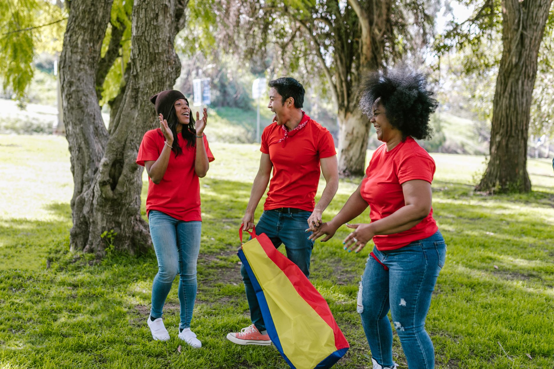 Diverse group of happy mothers and children at a park, fostering a sense of community.