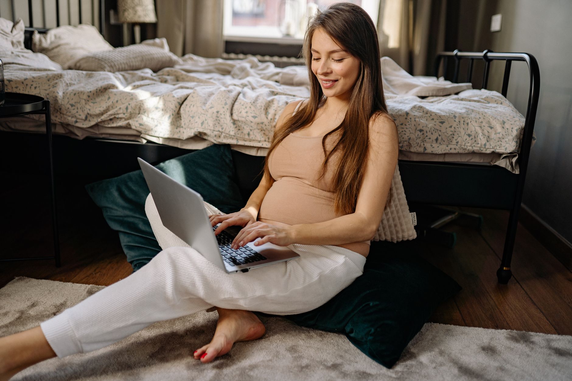 Pregnant woman with footstool and pillow