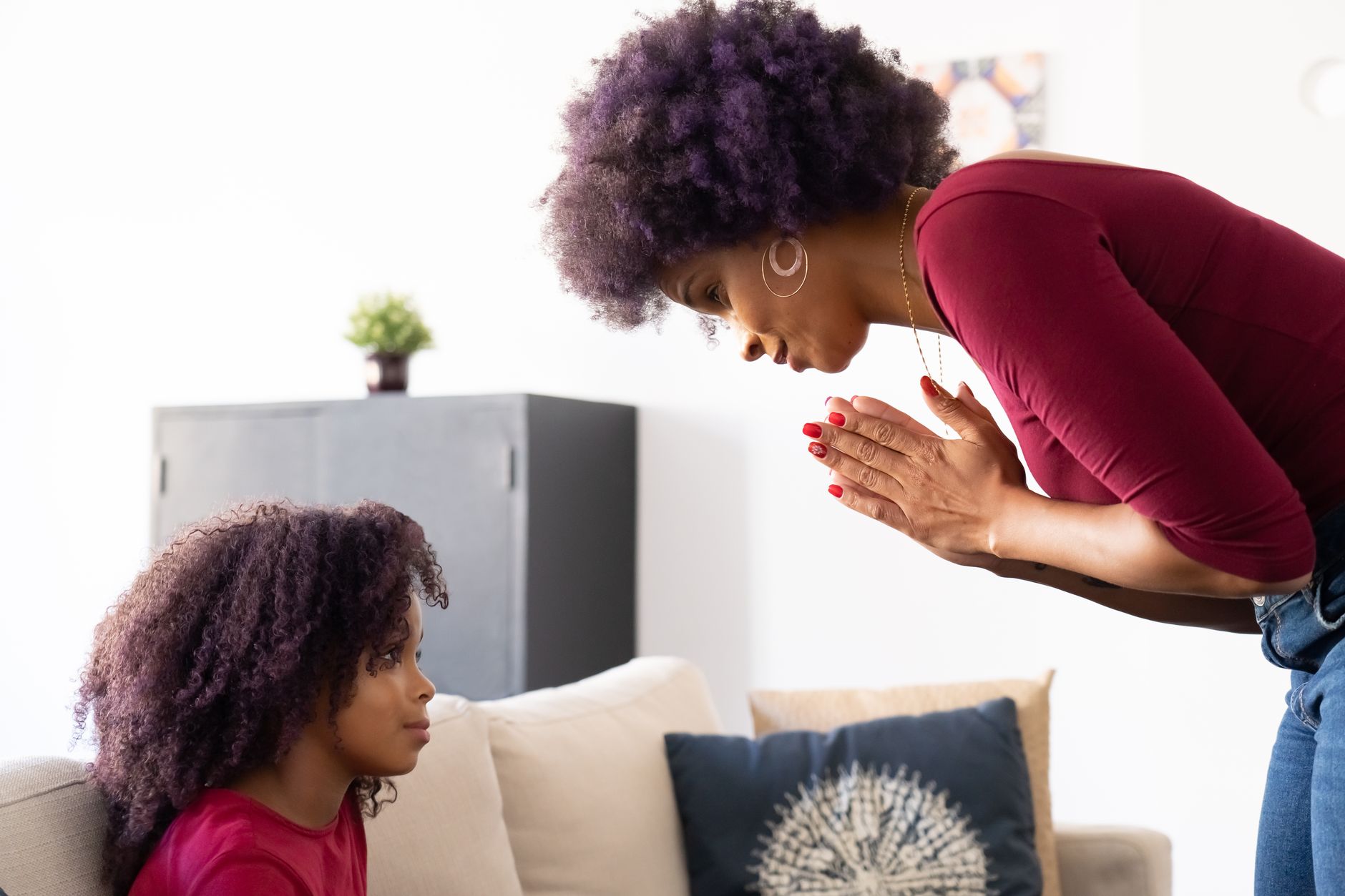 A mom sitting on a couch with her baby, holding a phone with a calendar app open to 'No Contact' notes