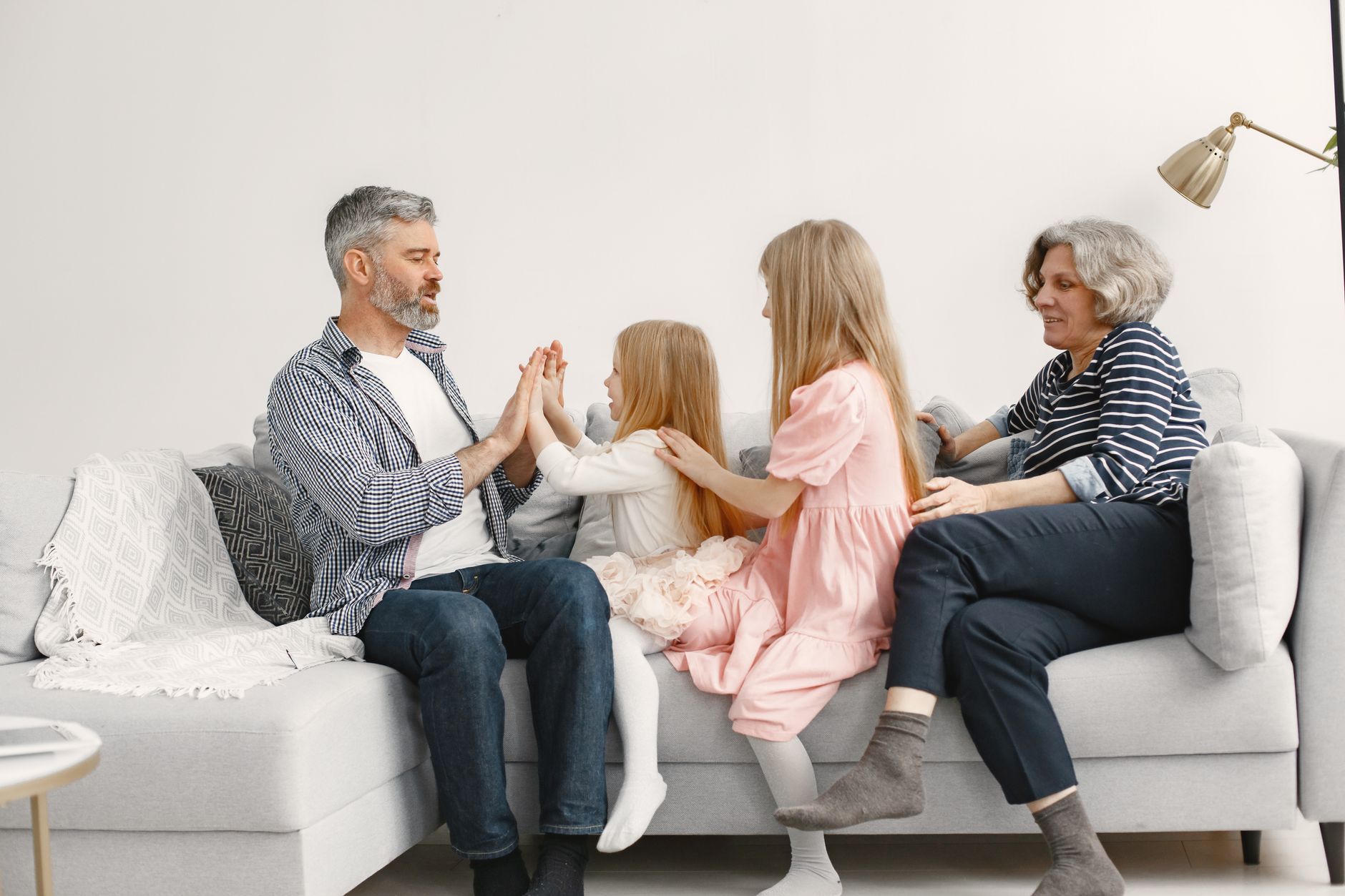 A joyful family playing together, representing healthy modern family dynamics fostered by shared parenting.