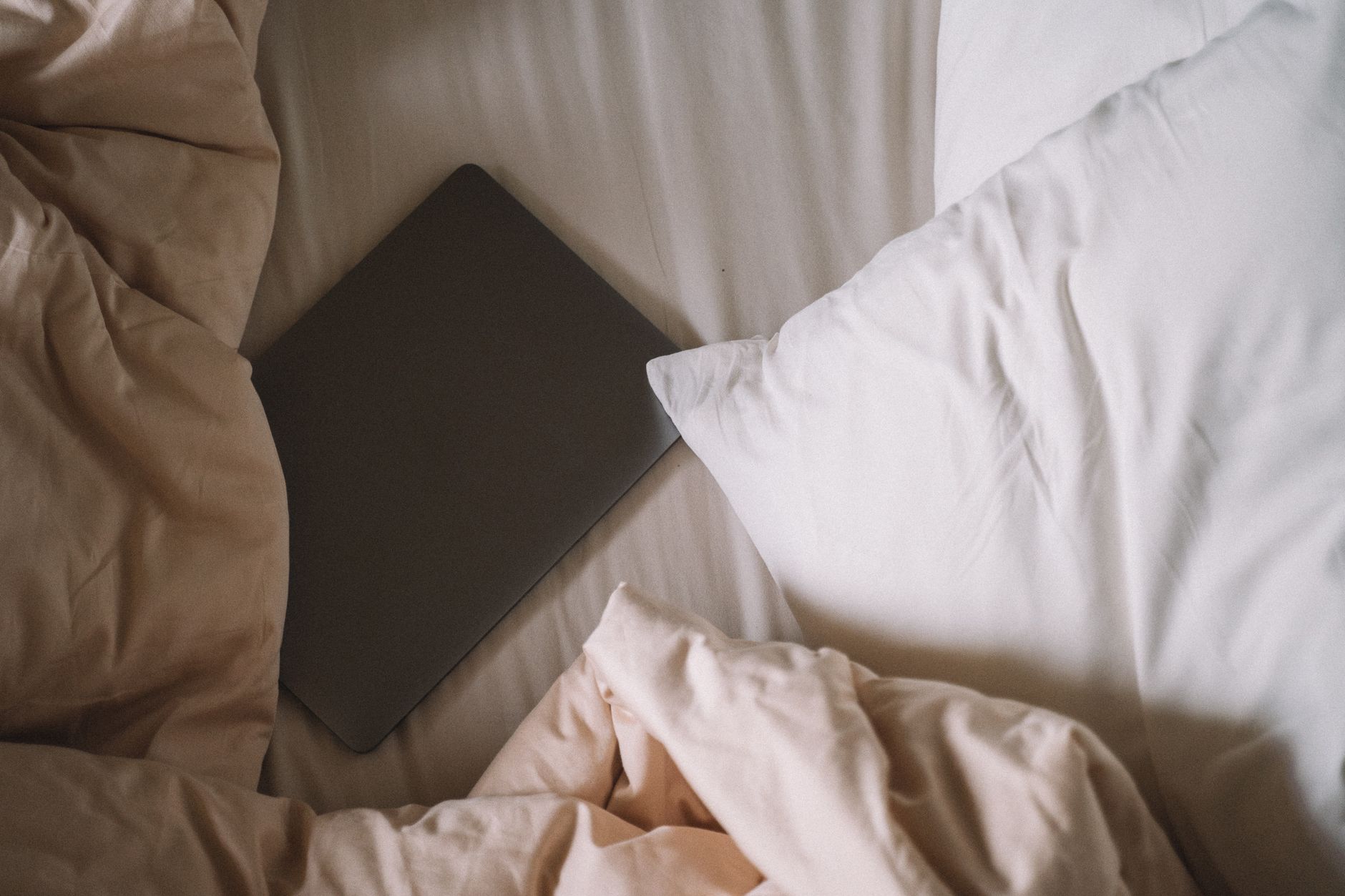 A comforting bedroom scene with a nightstand holding a water bottle, a pregnancy test, and a planner, soft morning light