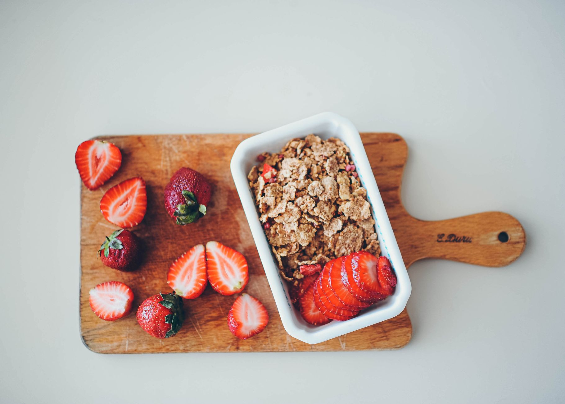 A colorful plate of baby-friendly foods—pureed carrots, apples, and bananas—arranged on a wooden board, bright natural light, inviting and nutritious