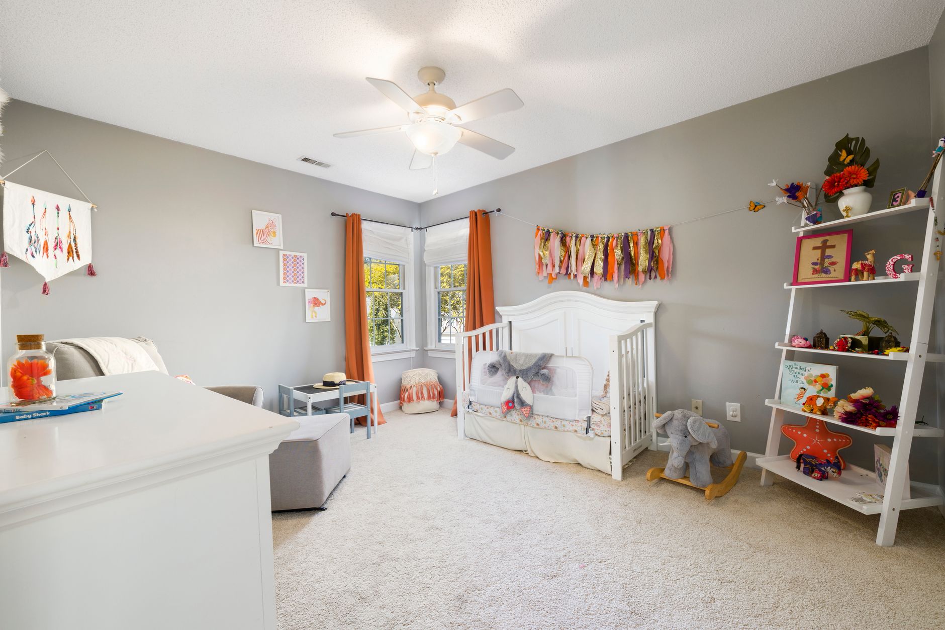 Baby’s nursery with neutral colors and cozy reading nook