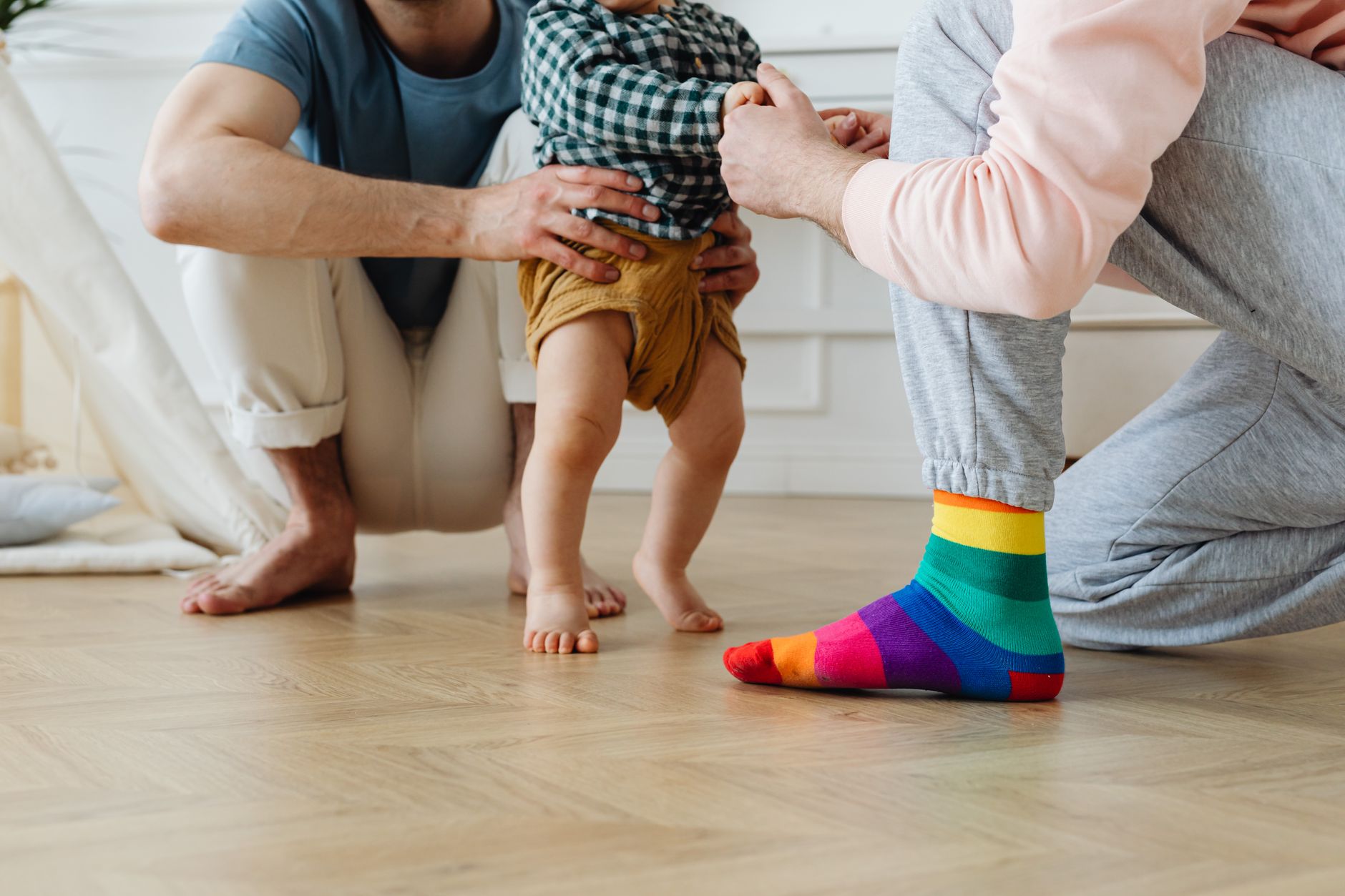 A toddler hugging both parents simultaneously, showing love and connection