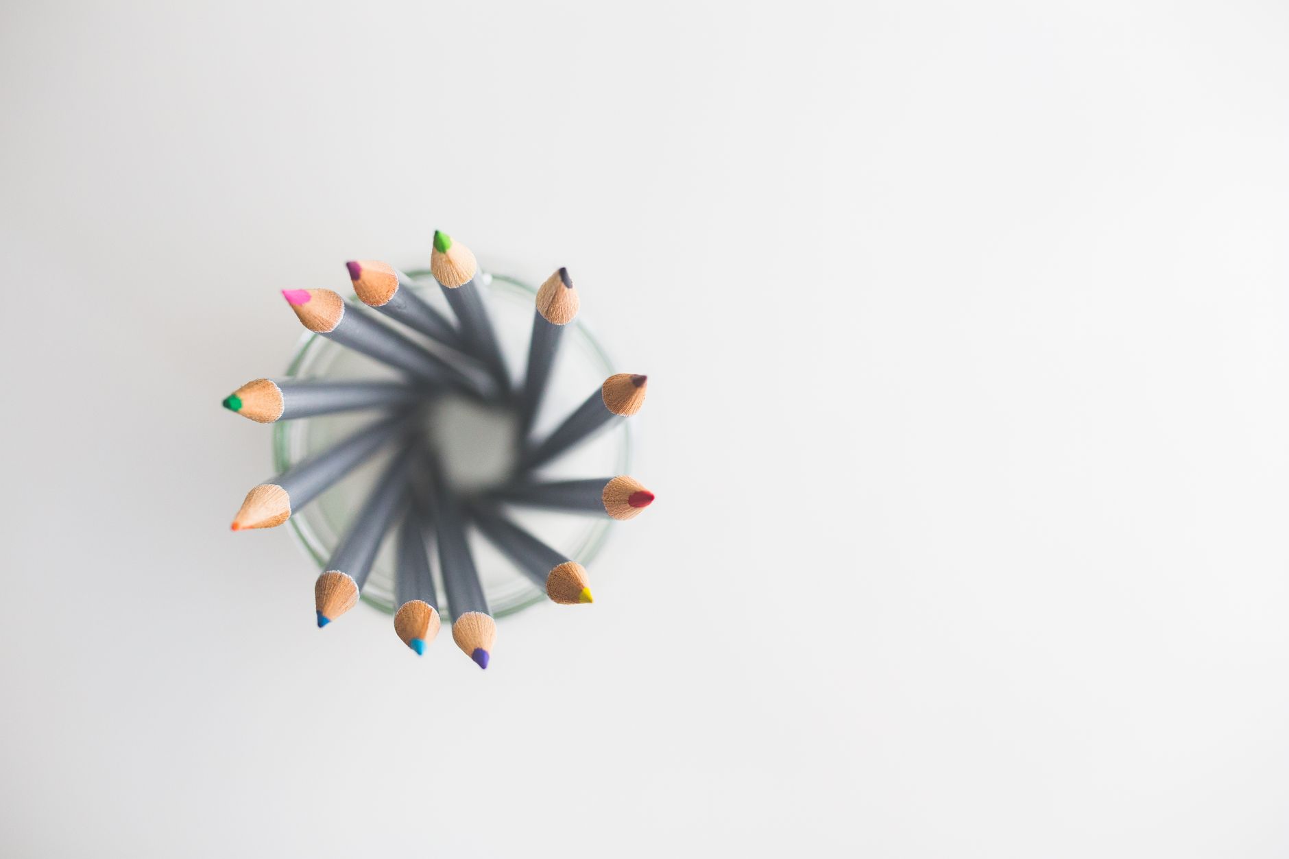 A wooden board filled with colorful puzzle pieces, crayons, and a small stack of picture books, arranged for a toddler’s quiet activity time