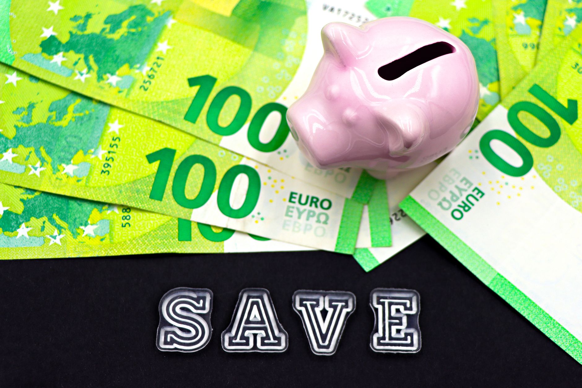 A smartphone screen showing a high-yield savings account with a 4.5% APY, next to a piggy bank labeled 'Emergency Fund'