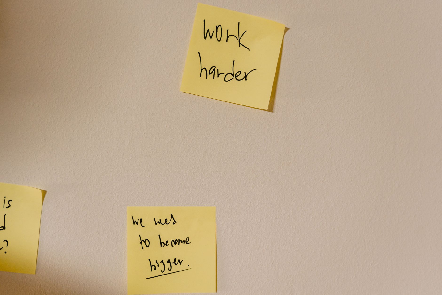 Handwritten note on a desk that reads 'I am enough' next to a framed baby photo