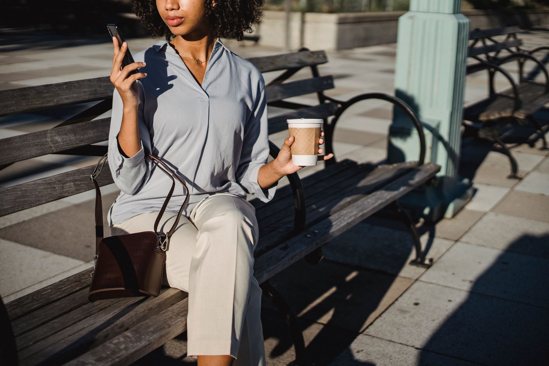 A woman sitting alone in a park, deep in thought