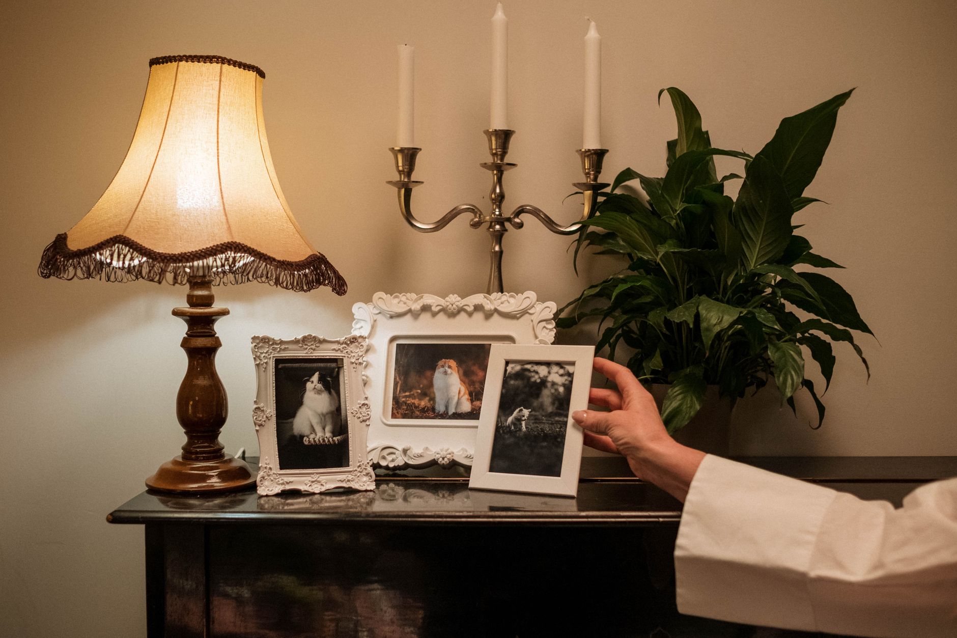 A woman holding a photo of her mother with small gifts around her