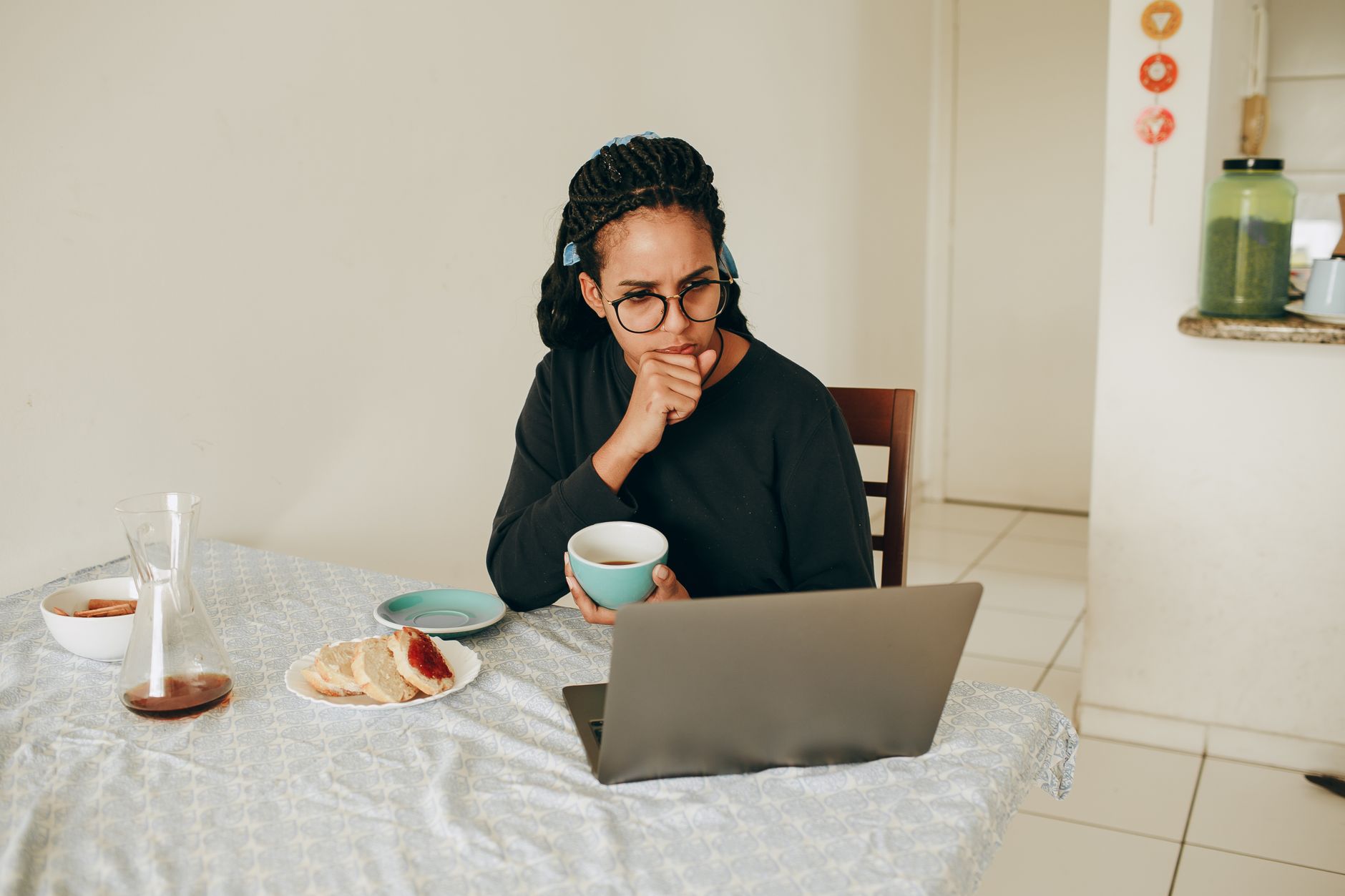 A woman journaling with a photo of her mother on the table