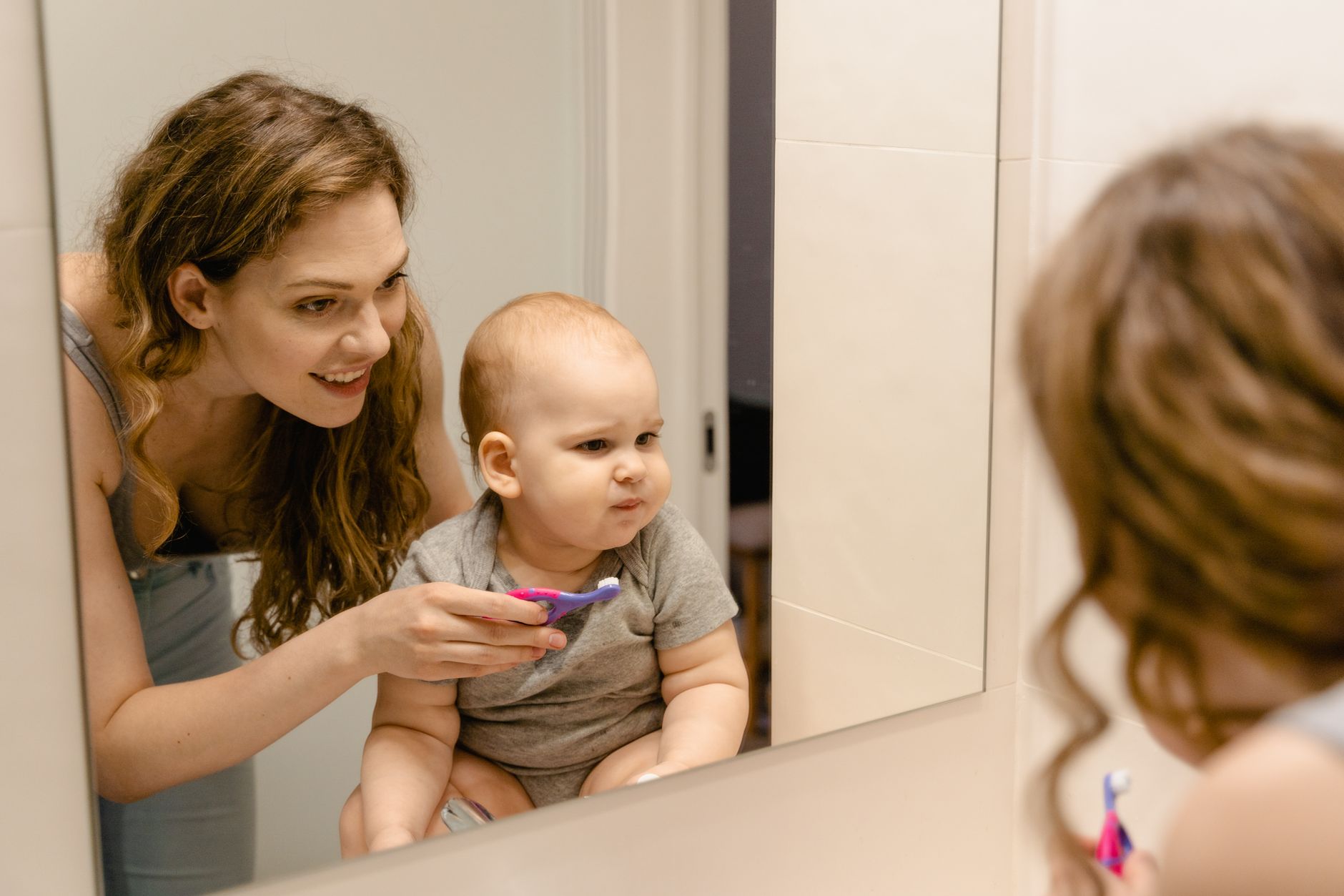 Mother brushing teeth at night