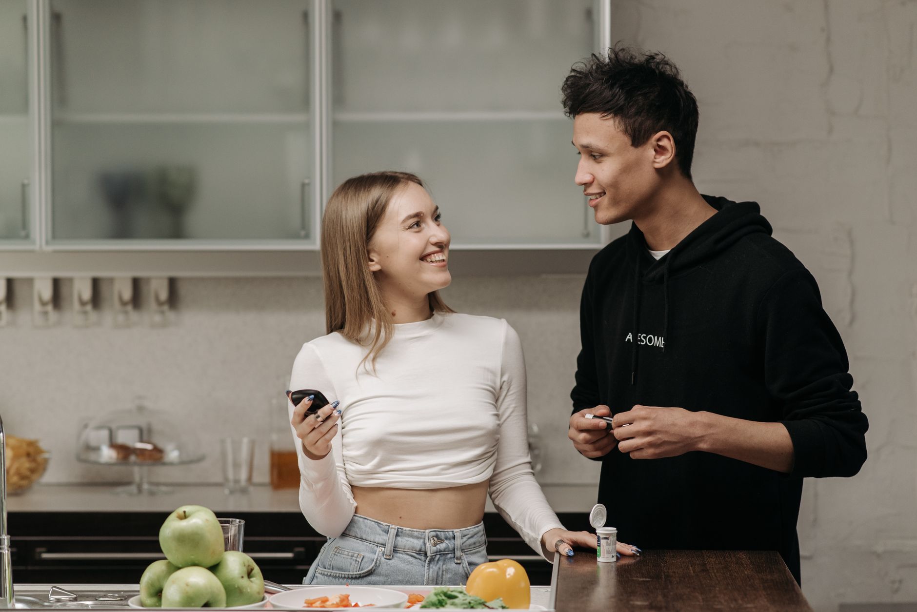 Pregnant woman monitoring blood sugar and preparing a gestational diabetes-friendly meal