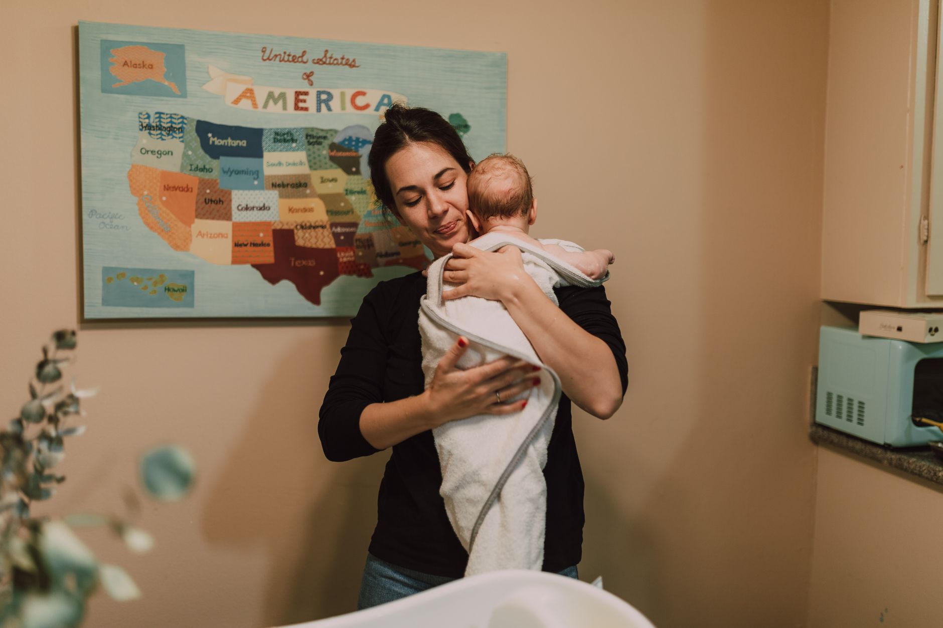 A new mom applying a warm compress to her perineum while sitting in a sitz bath.