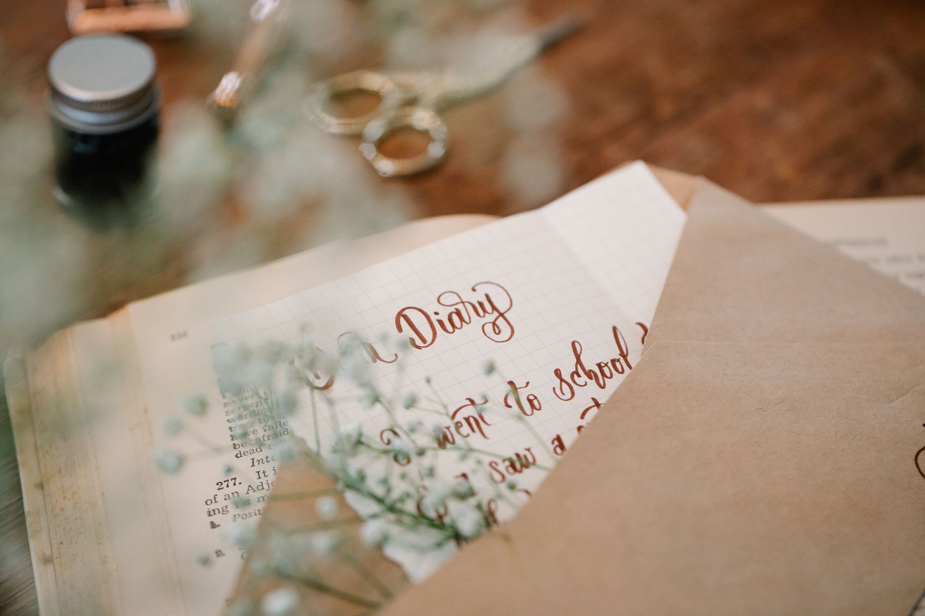 A pregnancy journal with a handwritten note about a grandmother, surrounded by photos and a small plant