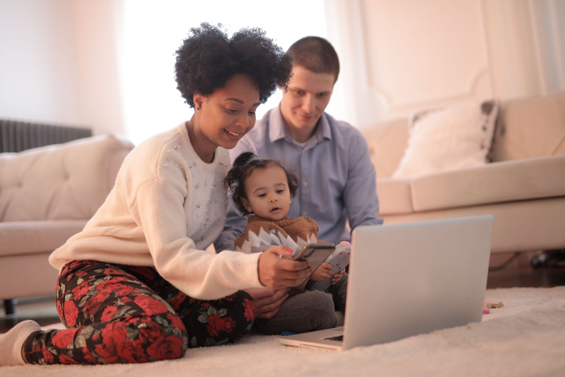 A co-parent offering support while the other parent communicates boundaries on their phone.