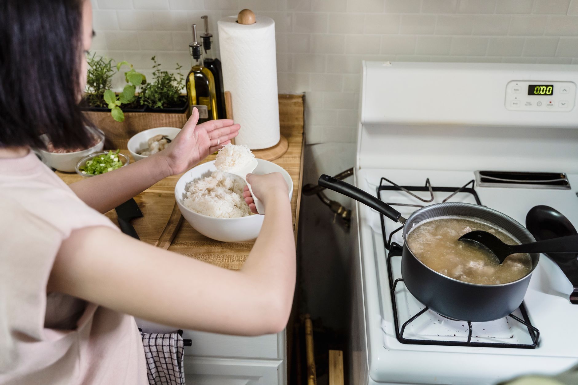 Granola mom cooking a healthy meal with sustainable kitchen tools.