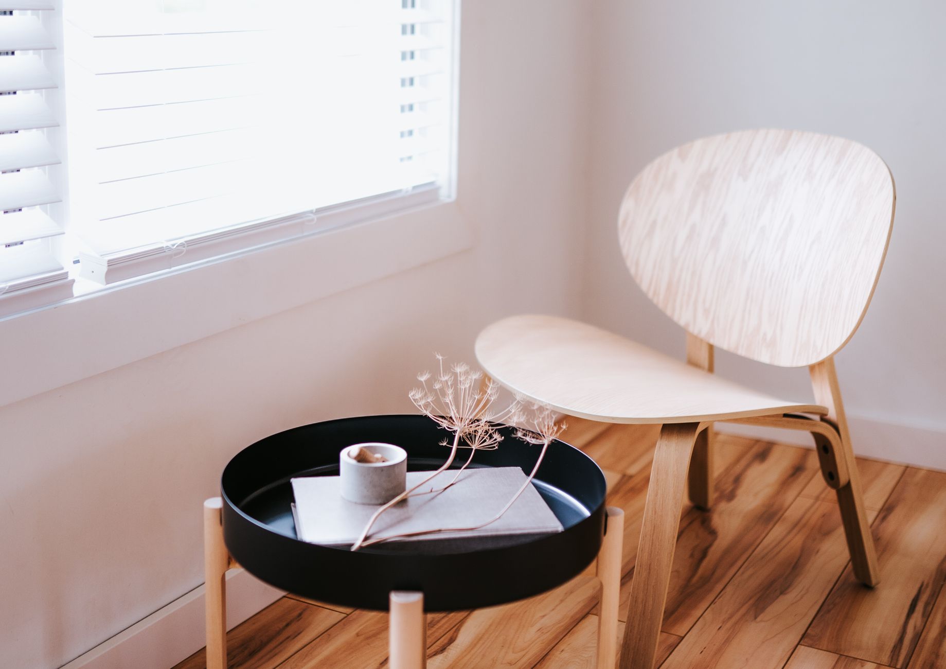 A cozy birthing room with a wooden rocking chair, soft blankets, and a small tray holding a penicillin vial and syringe, warm ambient lighting