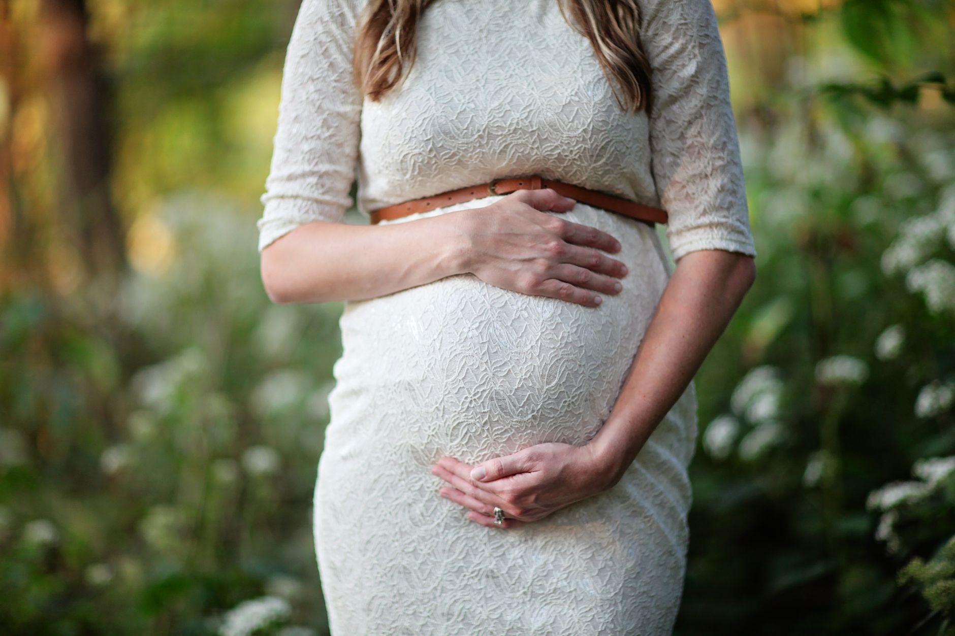 Pregnant woman holding belly with healthy food