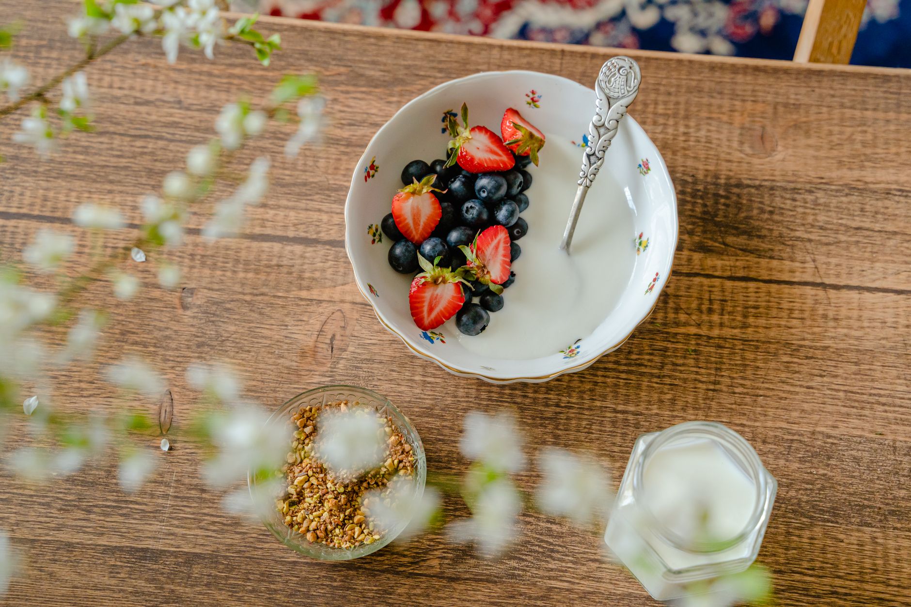 Fresh berries and prenatal vitamins on a kitchen counter