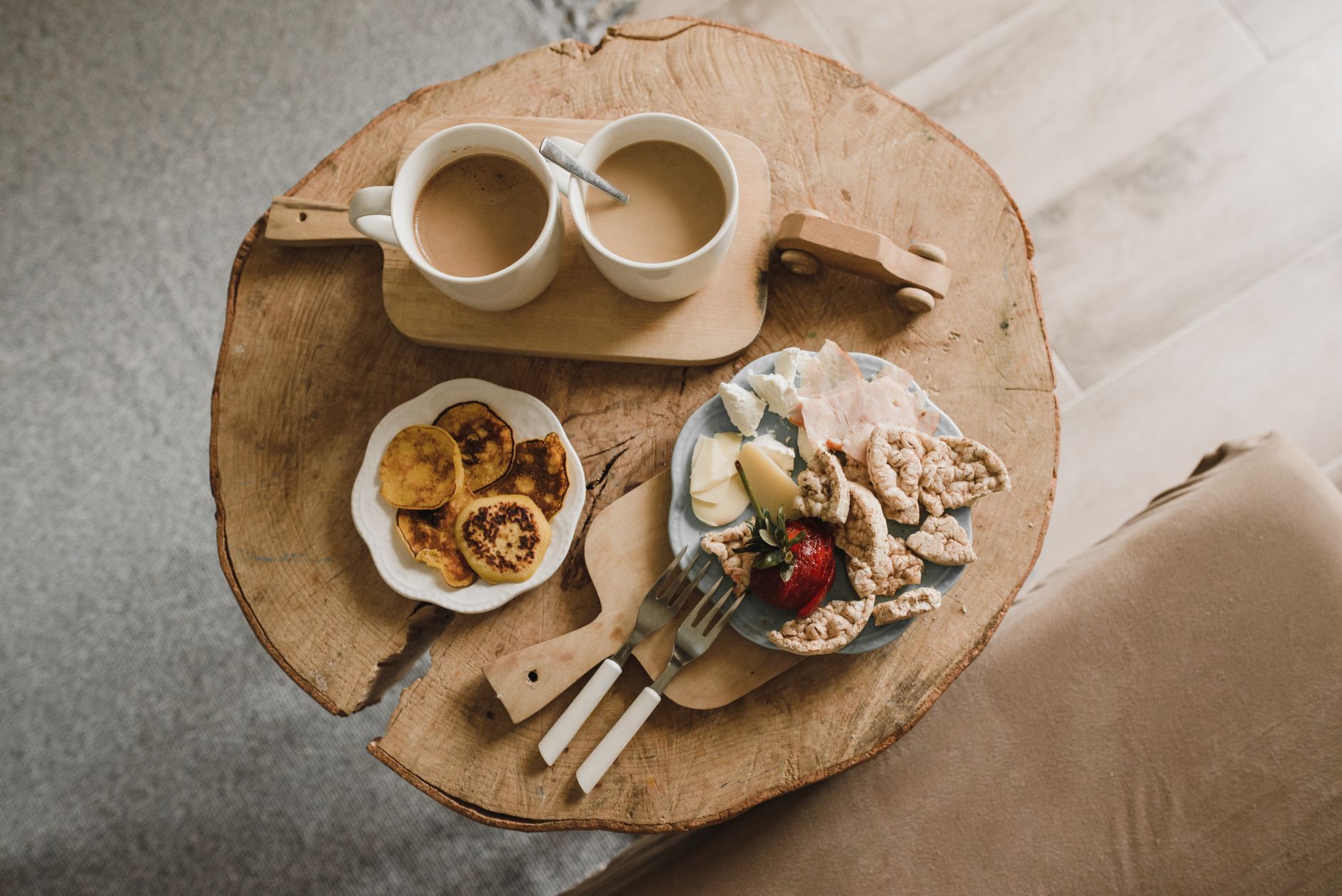 Freshly cut strawberries, almond butter, and a glass of water on a wooden breakfast board, bright natural light, inviting morning vibe