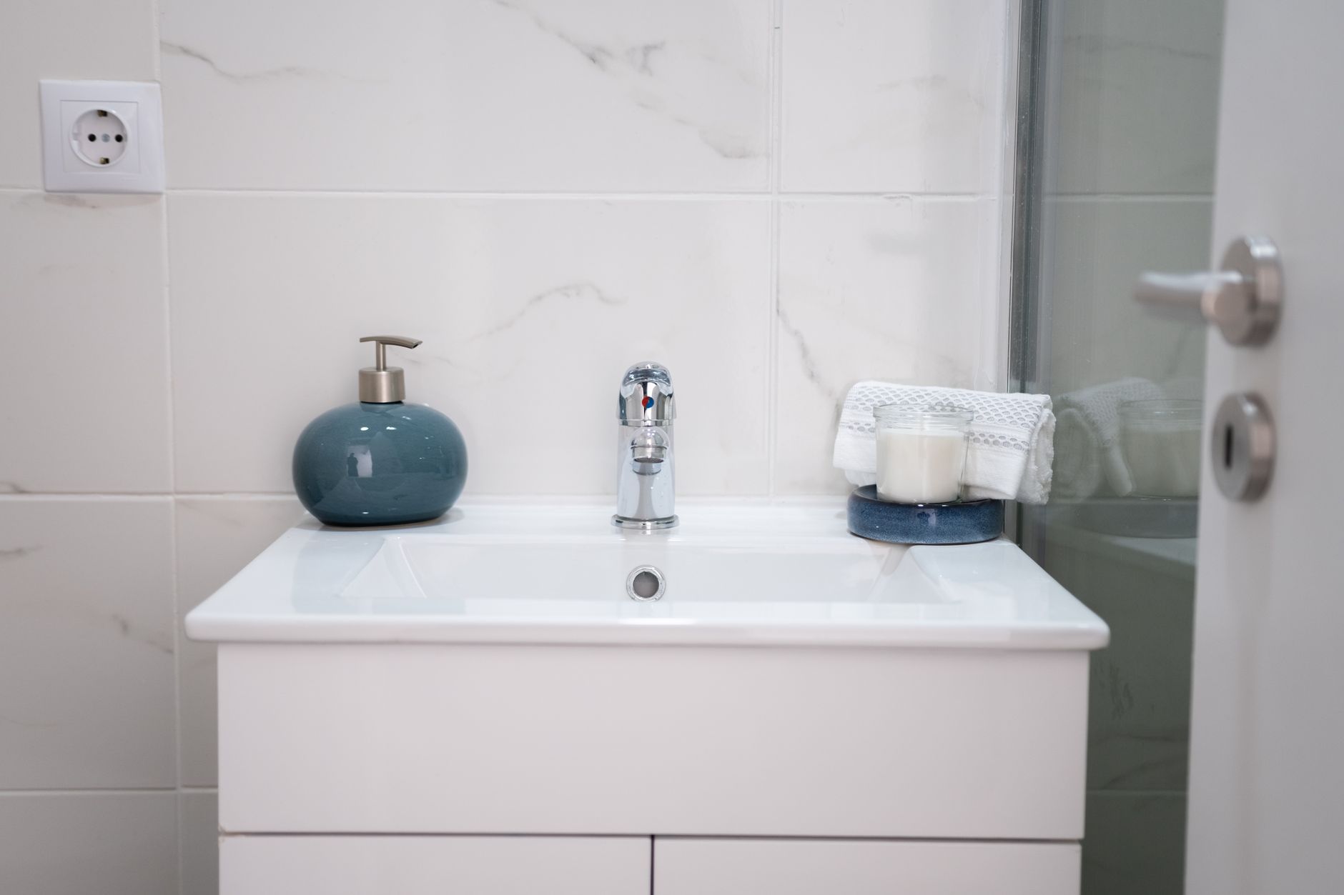 A well-organized bathroom sink with soap dispenser, clean towels, and a child's toothbrush, emphasizing good hygiene