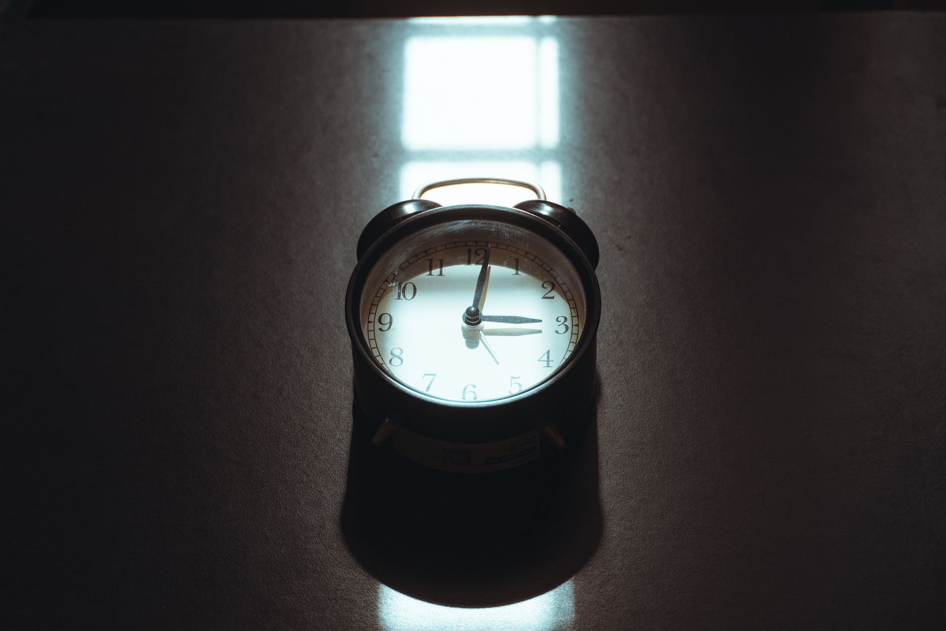 A supportive birthing partner gently guiding a pregnant woman’s breathing while she pushes, soft natural light, a clock indicating minutes, cozy bedside table with water