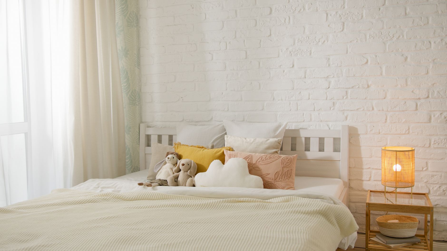 A cozy nursery scene with a diaper basket, a soft plush toy, and a baby monitor on a nightstand