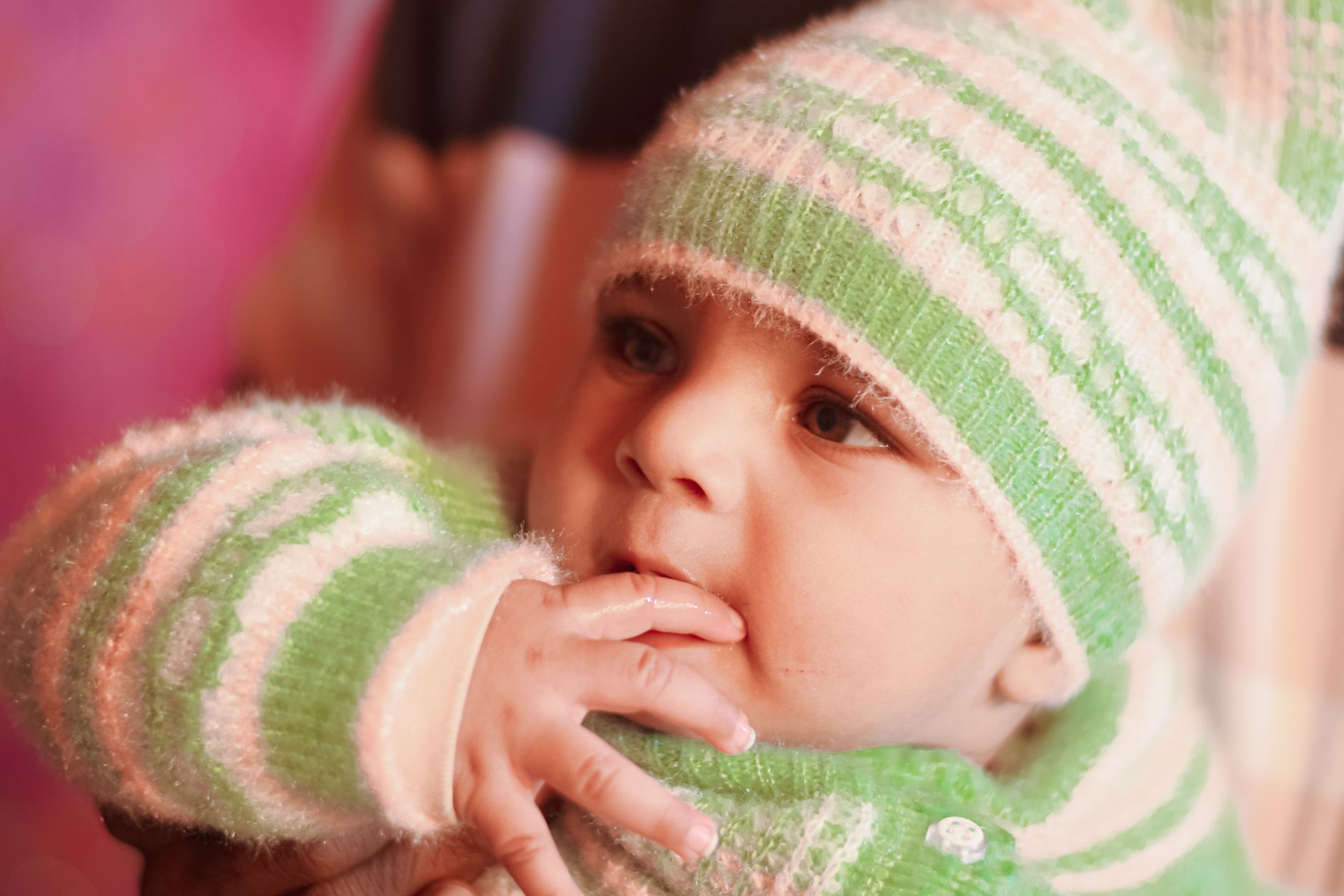 A 2-month-old baby showing hunger cues