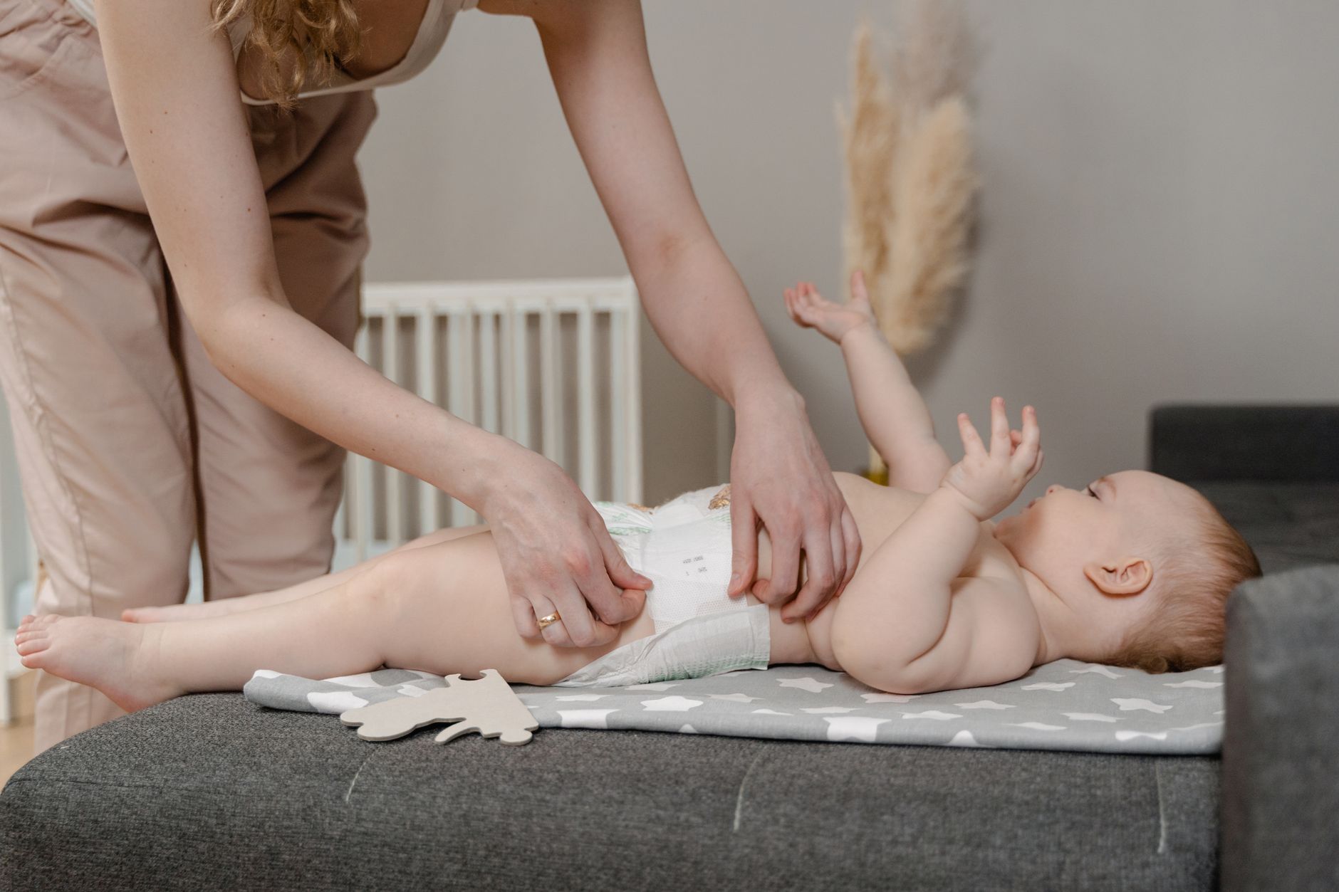 A concerned parent checking their baby's diaper for signs of irritation or blood