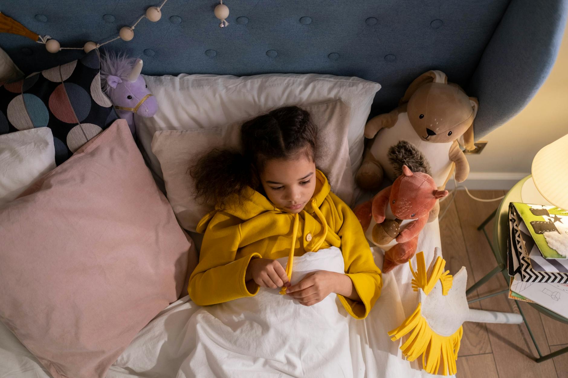 A week‑by‑week sleep chart displayed on a tablet, surrounded by soft baby toys and a plush blanket