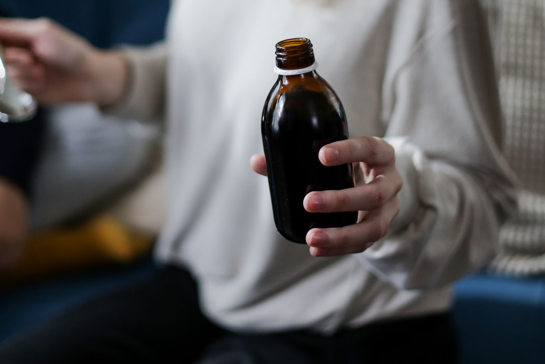 Parent measuring melatonin dose for infant
