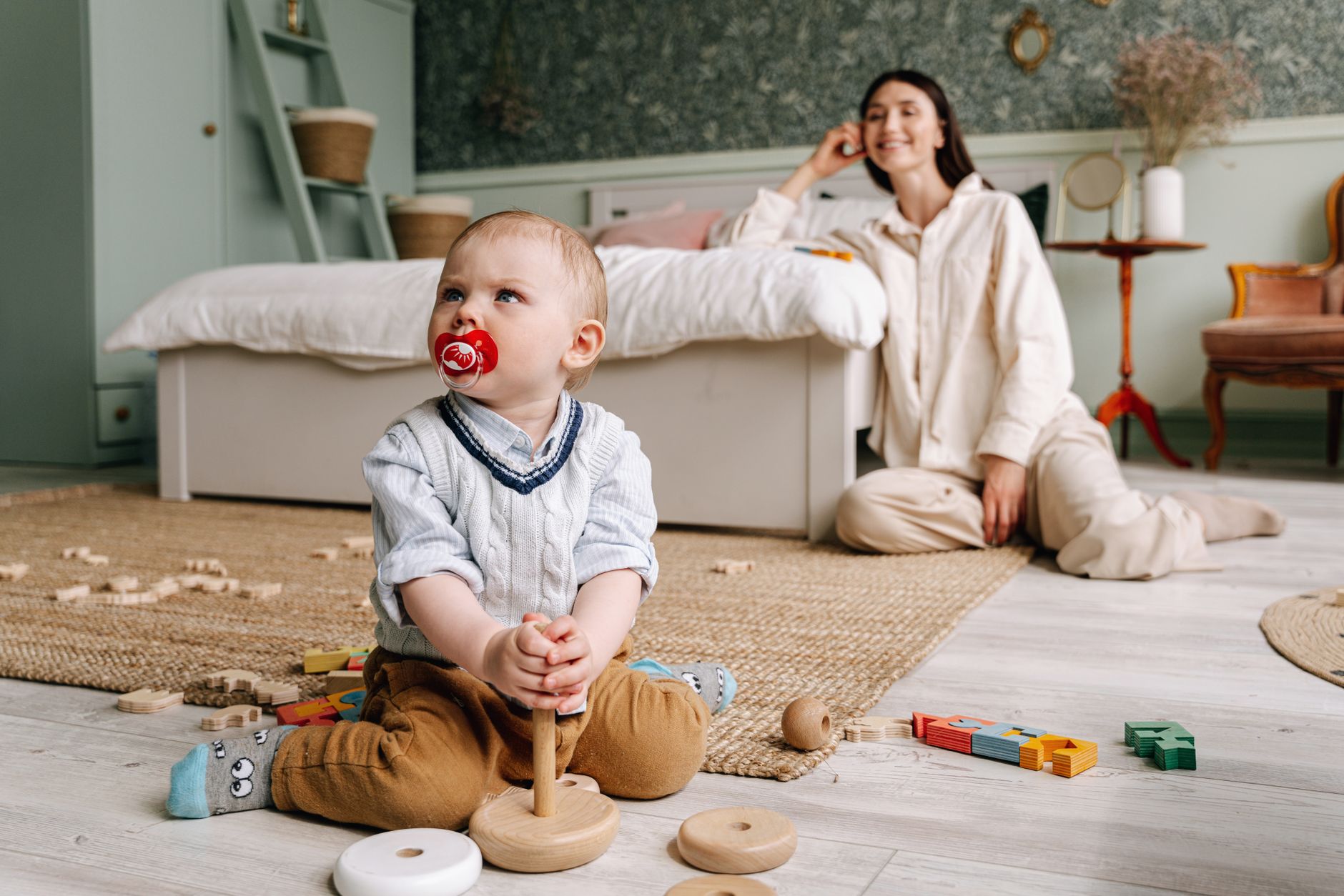 A mother and toddler sharing a joyful moment while playing with blocks.