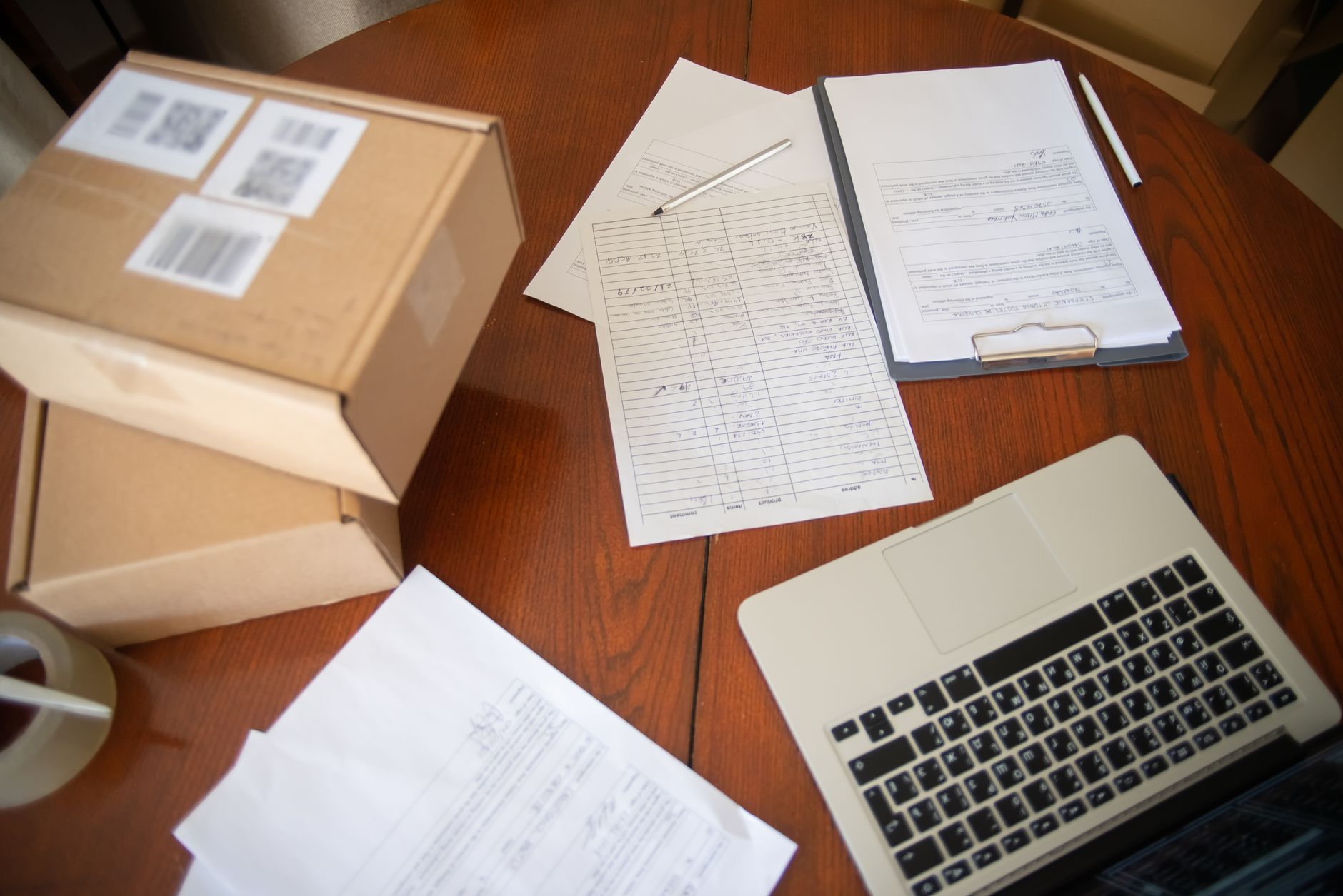 A tidy home office desk with two labeled folders—one for each twin—next to a laptop displaying a health insurance portal